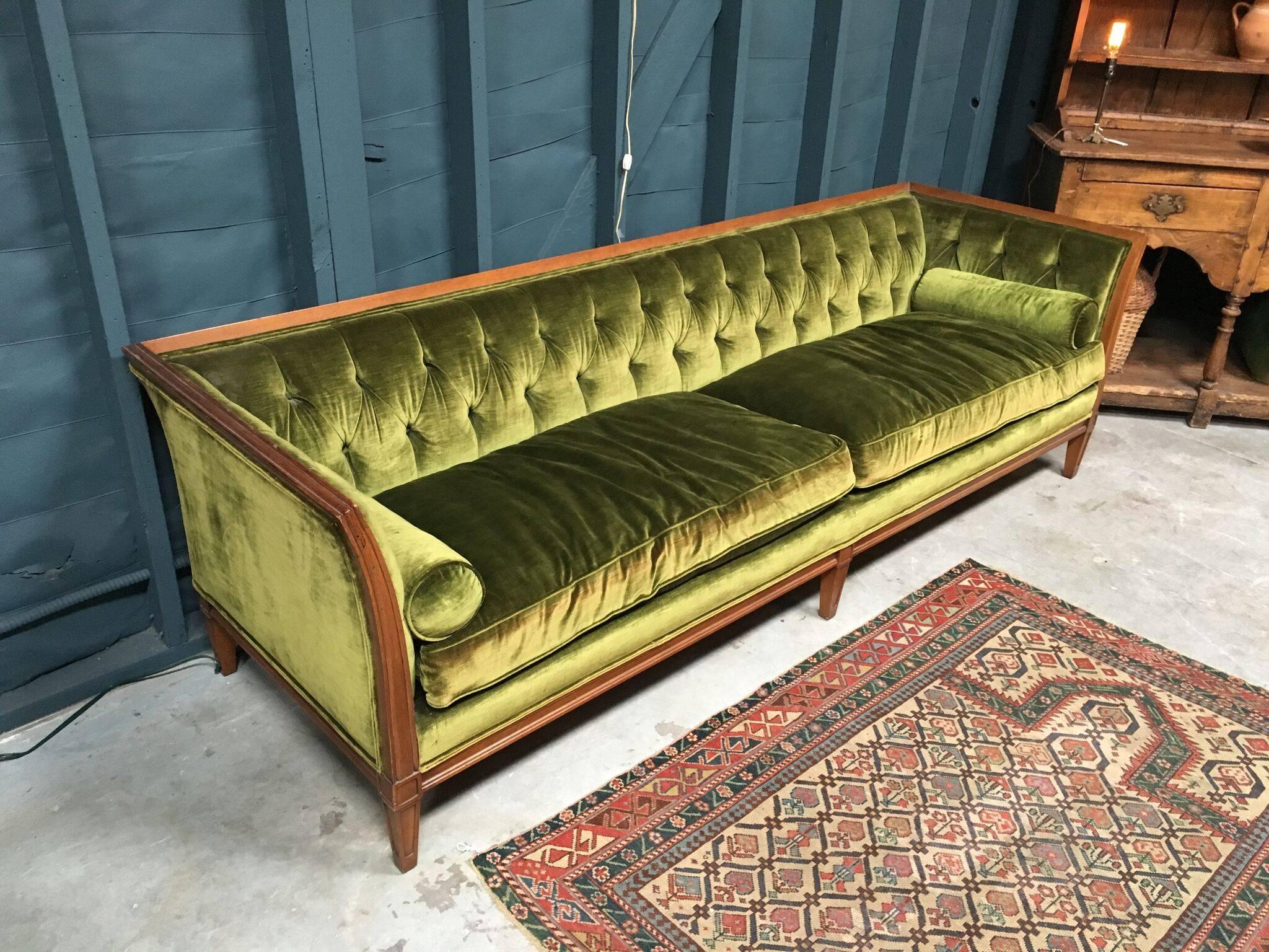 Beautiful green velvet sofa with two bolster pillows, from France and in great condition. Subtle Fabric reddening on front of cushions, but otherwise pristine.