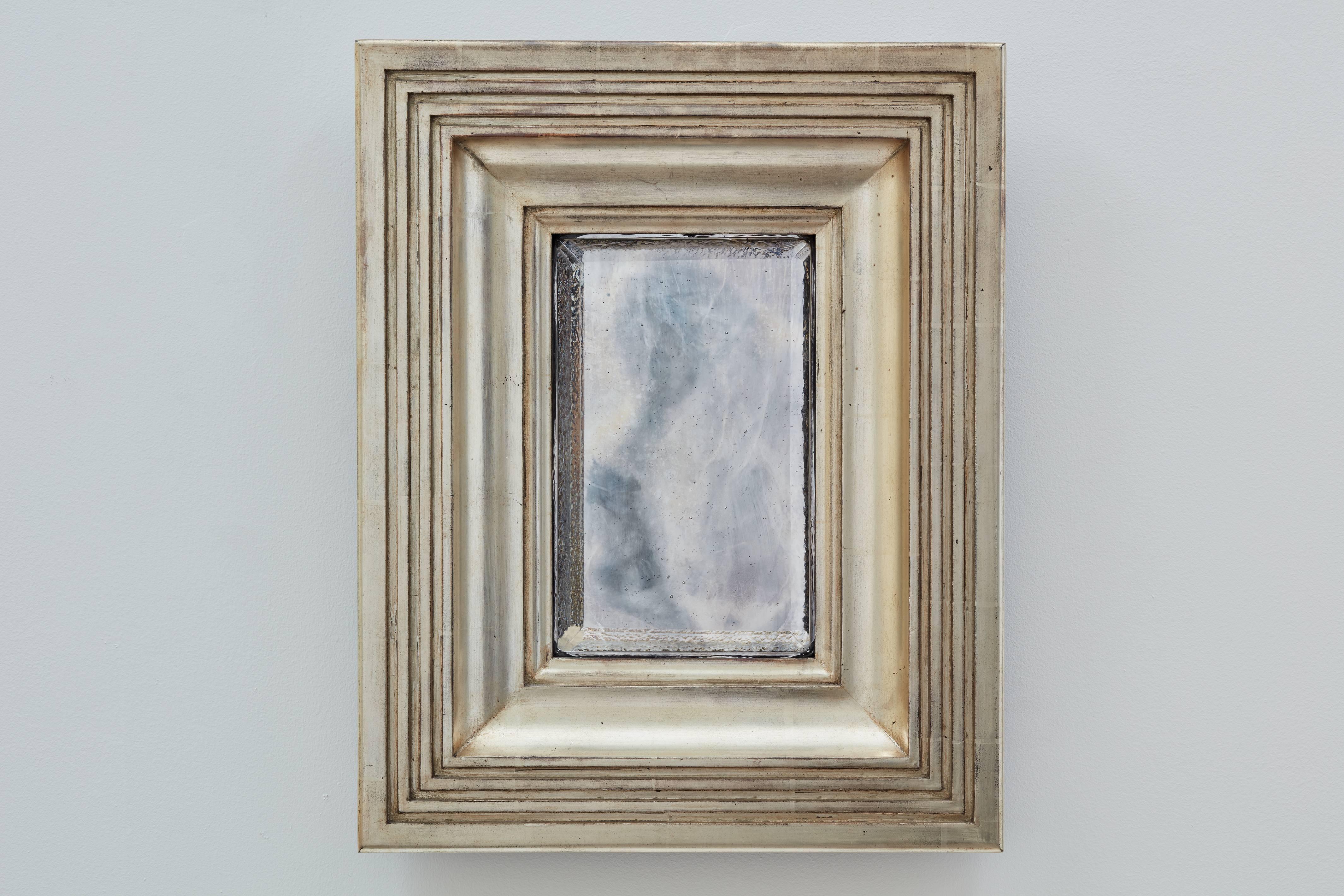 The Degas No. 4 mirror by Bark Frameworks. Degas is based on a design by Impressionist painter Edgar Degas (1834-1917), from his notebooks of 1878-1879. The frame, which has exaggerates flutes and reed on its sides, is gilded in 12-karat white gold