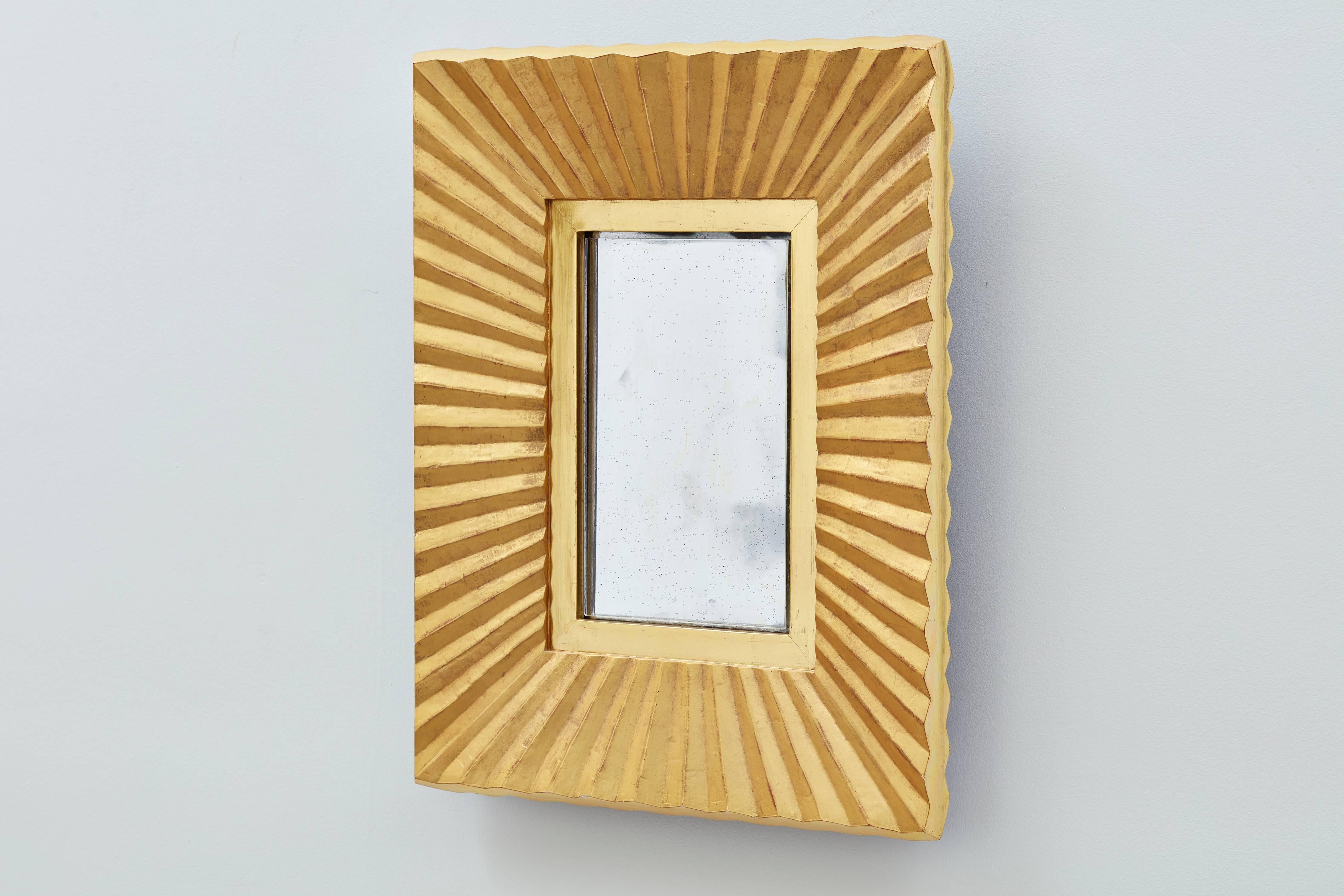 Pleated facets inform the name of this Bark Frameworks mirror, which was designed by company founder and artist Jared Bark. The entire maple frame is gilded in 23-karat yellow gold over dark red bole (clay). The pleats are matte; the inner panel and