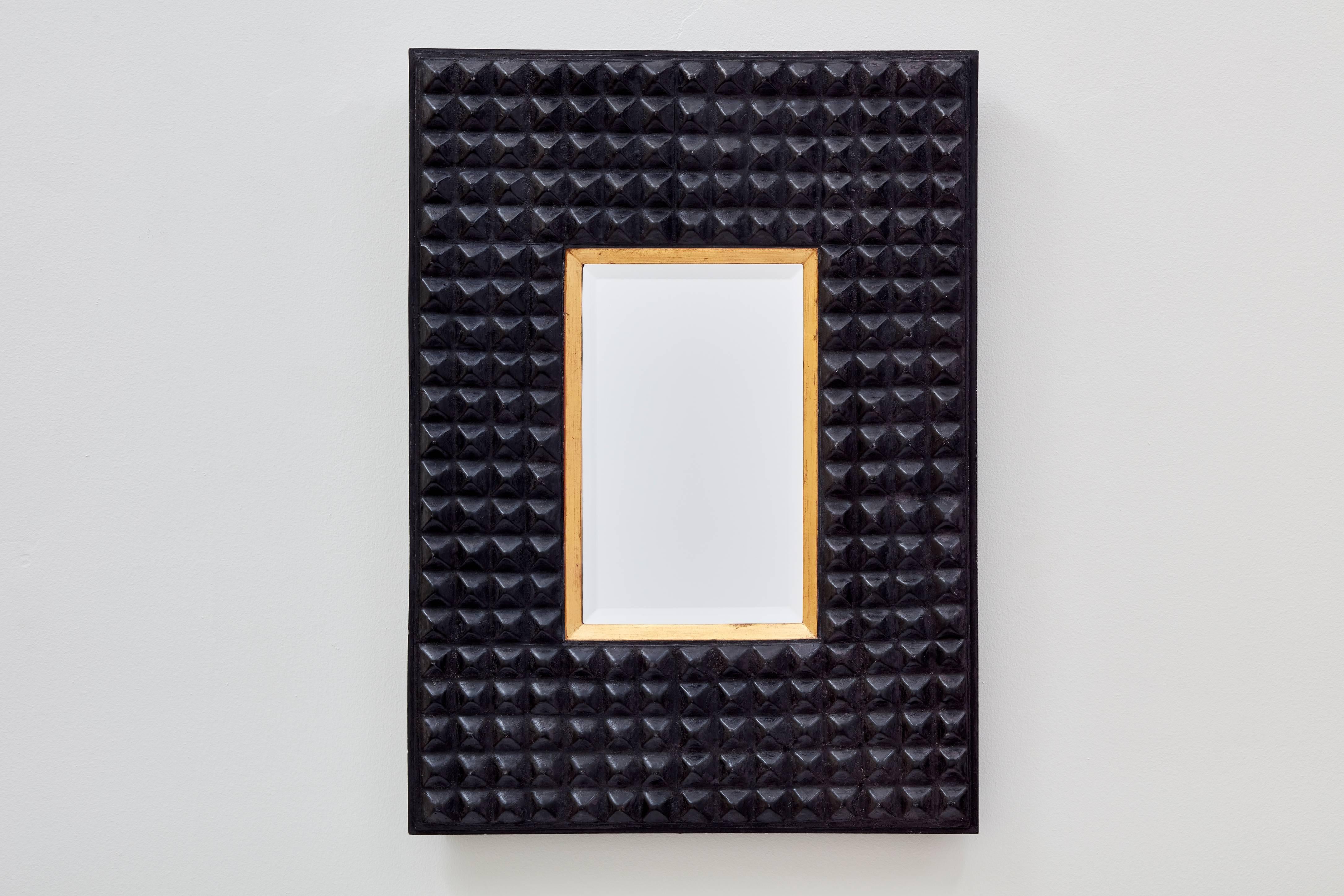 A perfectly imperfect rectangular shape, the studded surface and dark tone of the Ferarra mirror from Bark Frameworks evoke a tribal aesthetic. The mold for this mirror -- designed by Miguel Oks and Jared Bark -- was cast from a pressed tin