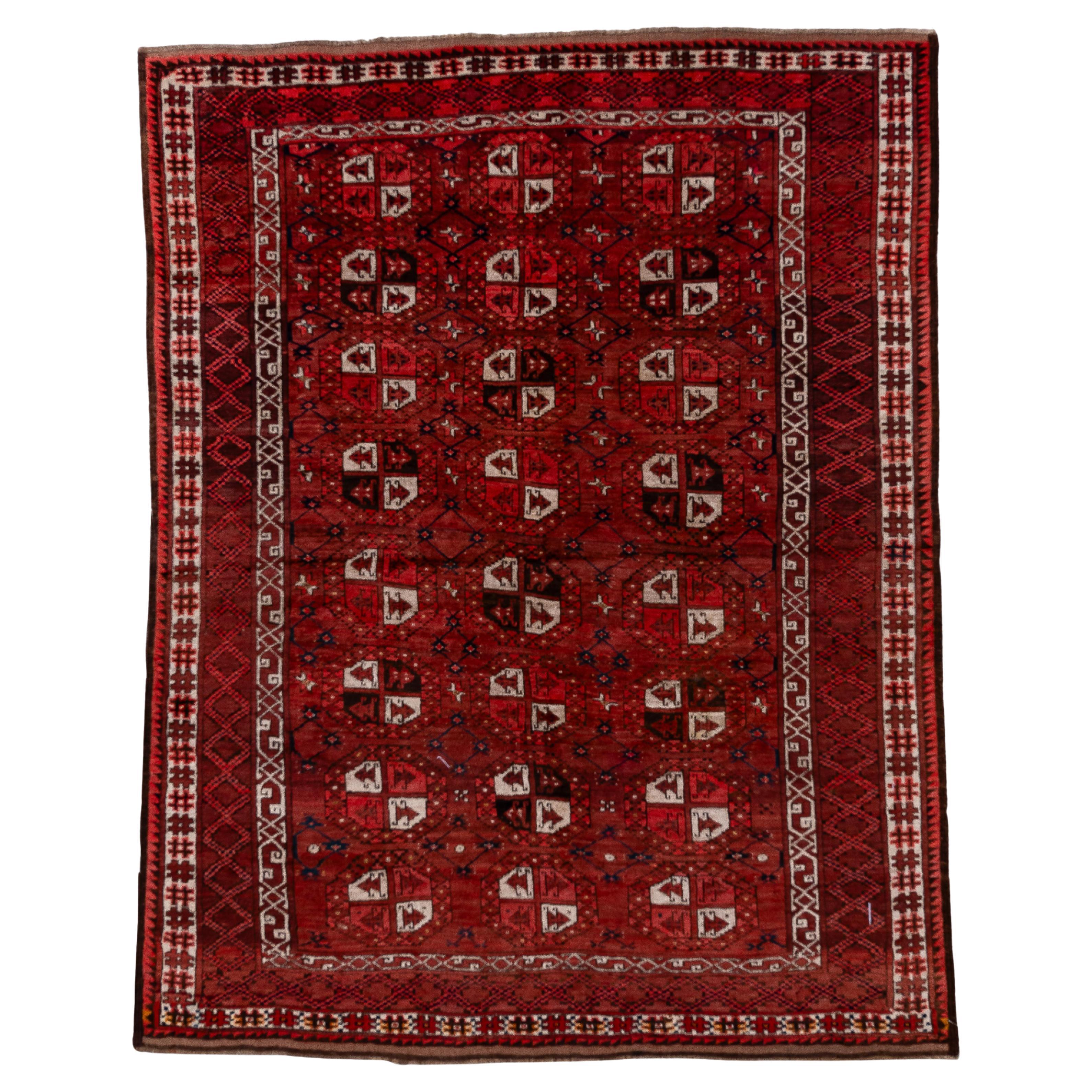 Vintage Afghan Rug with Deep Red Field and Repeating Gul Motifs For Sale