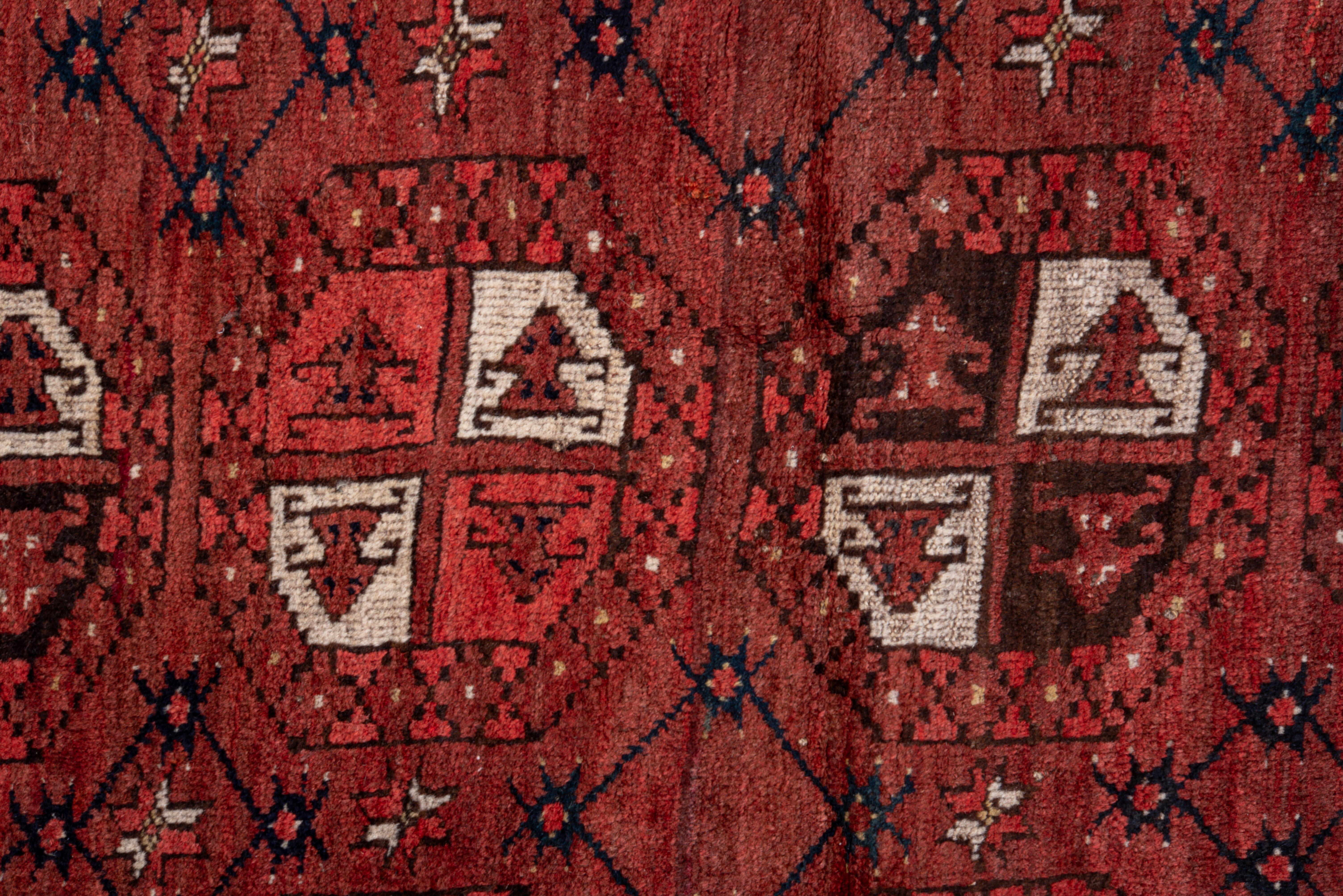 Wool Vintage Afghan Rug with Deep Red Field and Repeating Gul Motifs For Sale