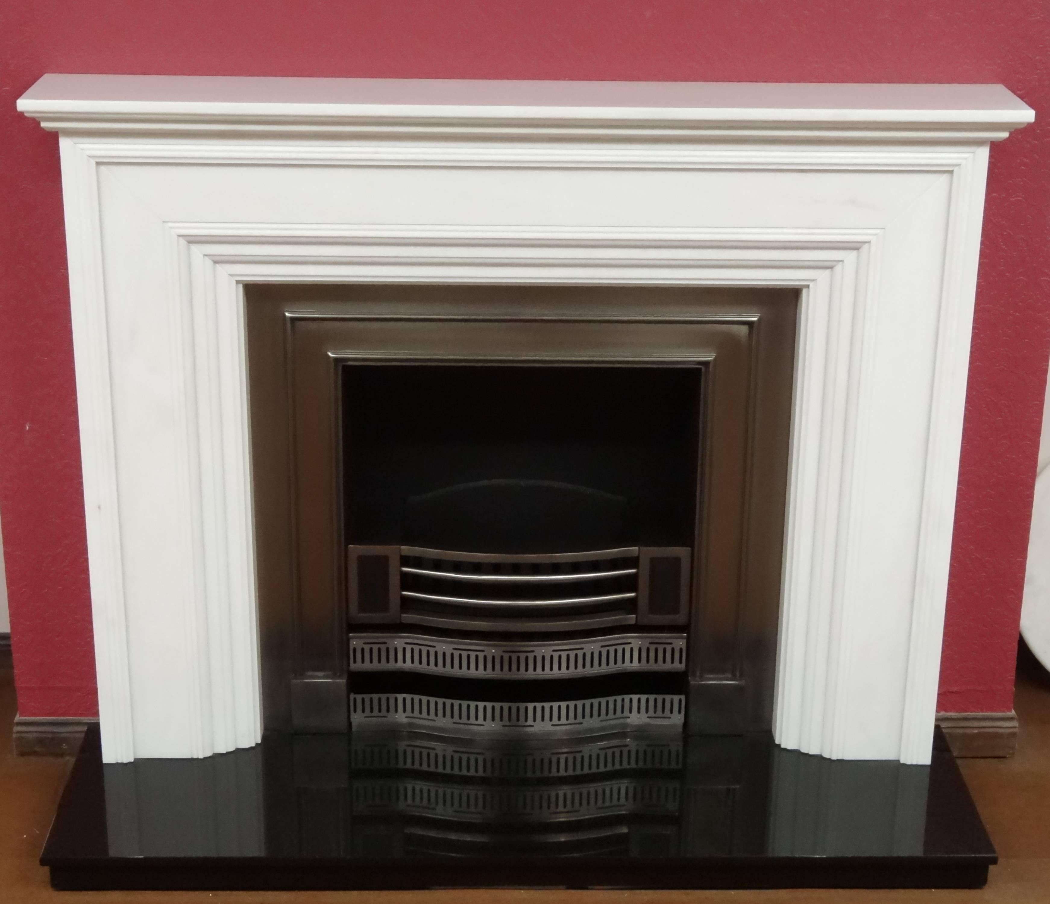 We created this contemporary fire surround from polished Portuguese Estrimoz marble. The fireplace comprises of a polished cast iron insert and polished black granite hearth.
Sample of the marble is available on request.

  