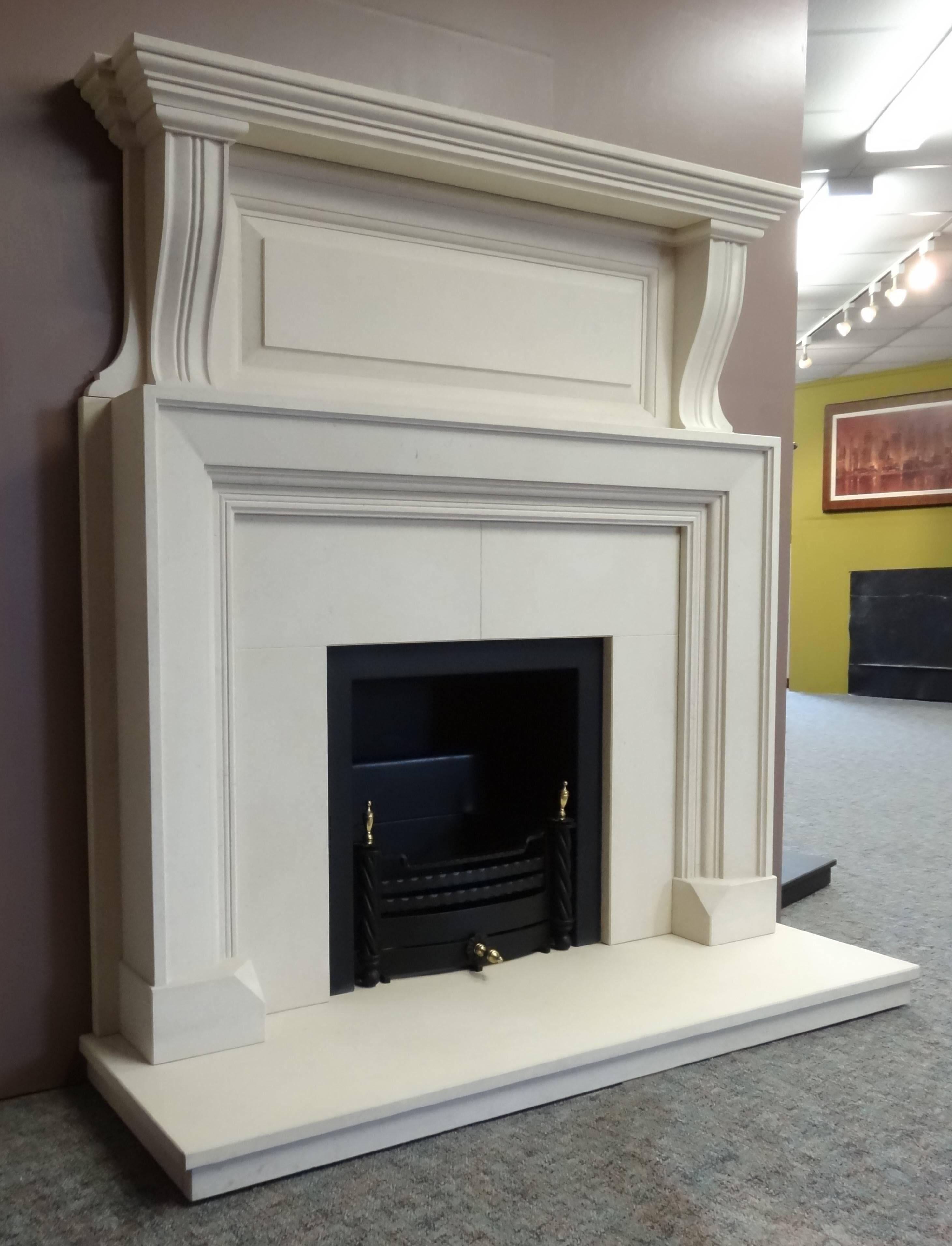 We created this fireplace in the Edwardian style from Limestone. The fireplace comprises a matching Limestone Hearth, a black metal fire trim built in to the Limestone Insert and a removable black and brass fire basket.

Measurements:
Mantel 62