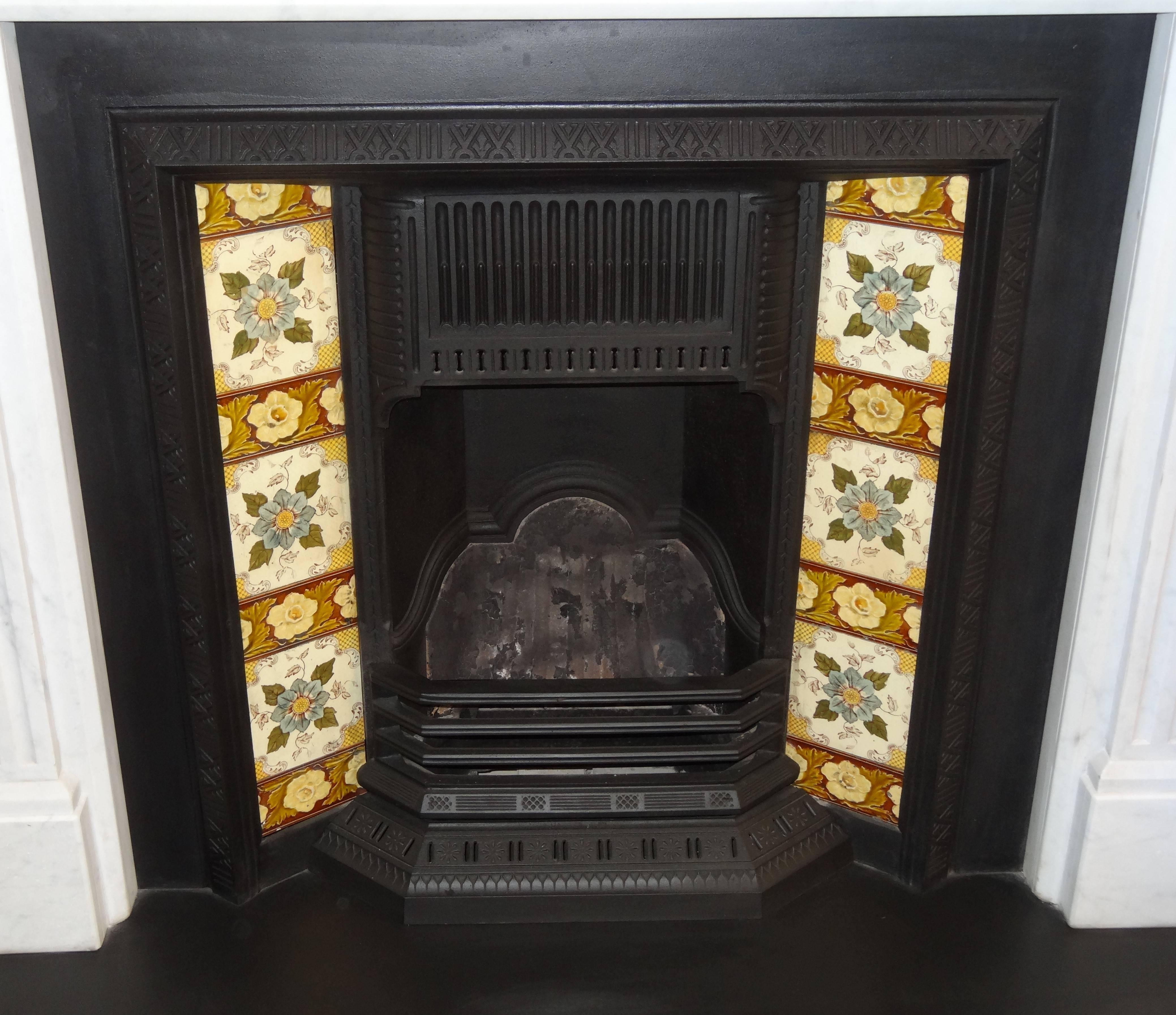 Reclaimed 19th century cast iron fireplace insert grate with antique tiles.