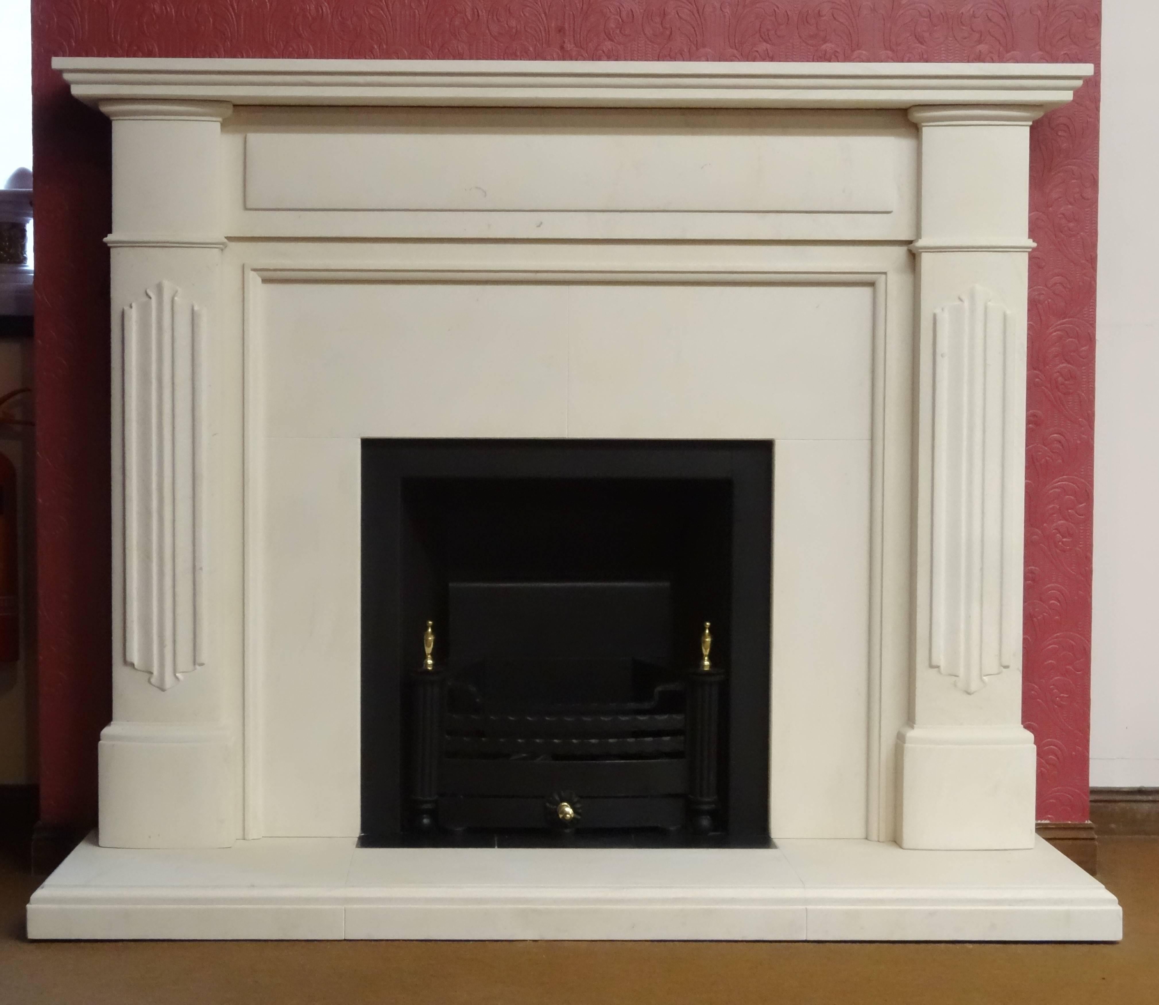 We carved this fireplace from honed Portuguese limestone. The fireplace surround is in the Edwardian style. The fireplace comprises of a matching limestone hearth and insert with a built in metal trim and a removable fire basket. Sample of this
