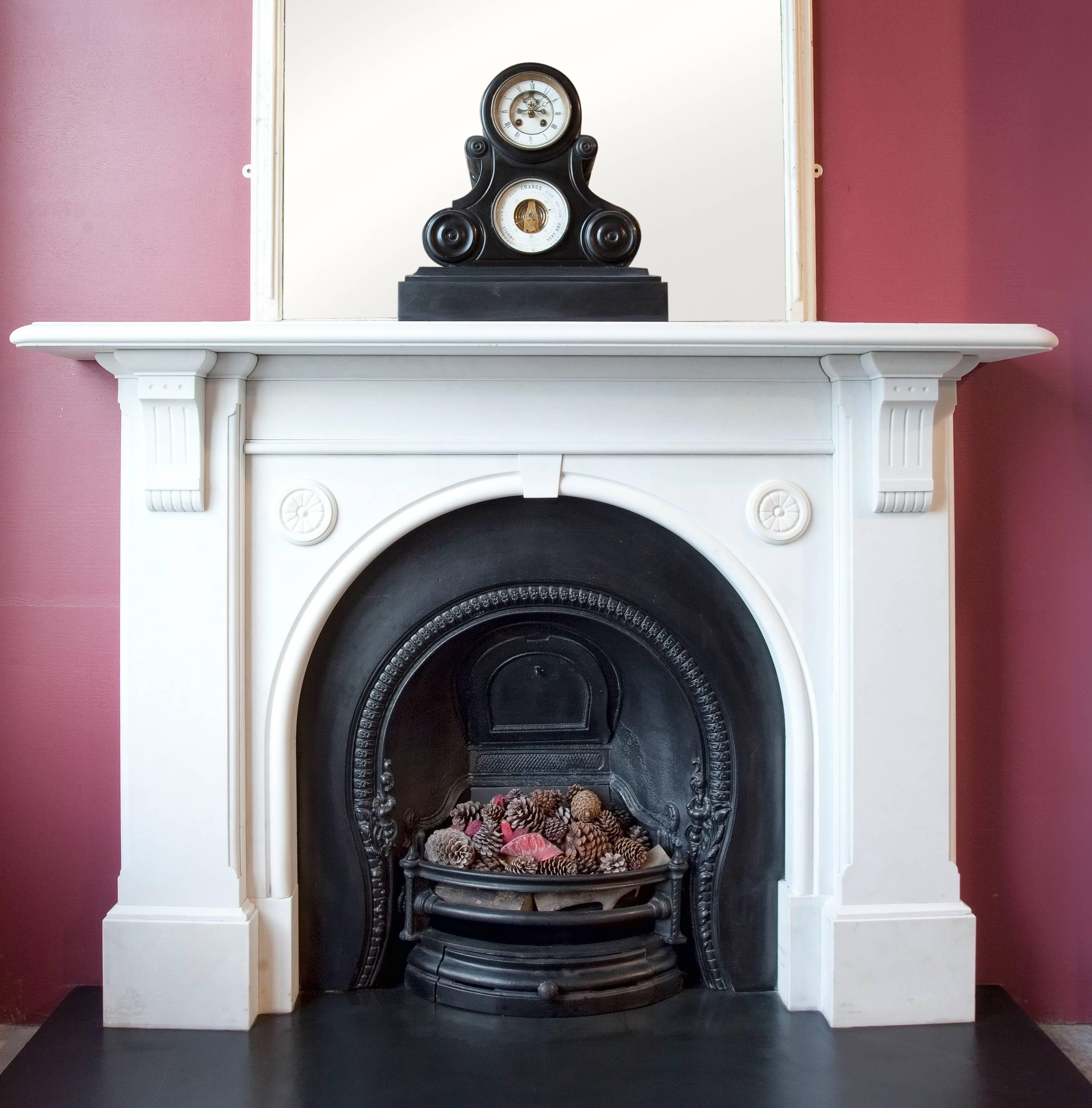 Antique 19th century Victorian statuary white marble fireplace surround with arched aperture.
The slate hearth, cast iron fire grate and accessories shown with the fireplace surround are not included in the price.

Aperture approximate