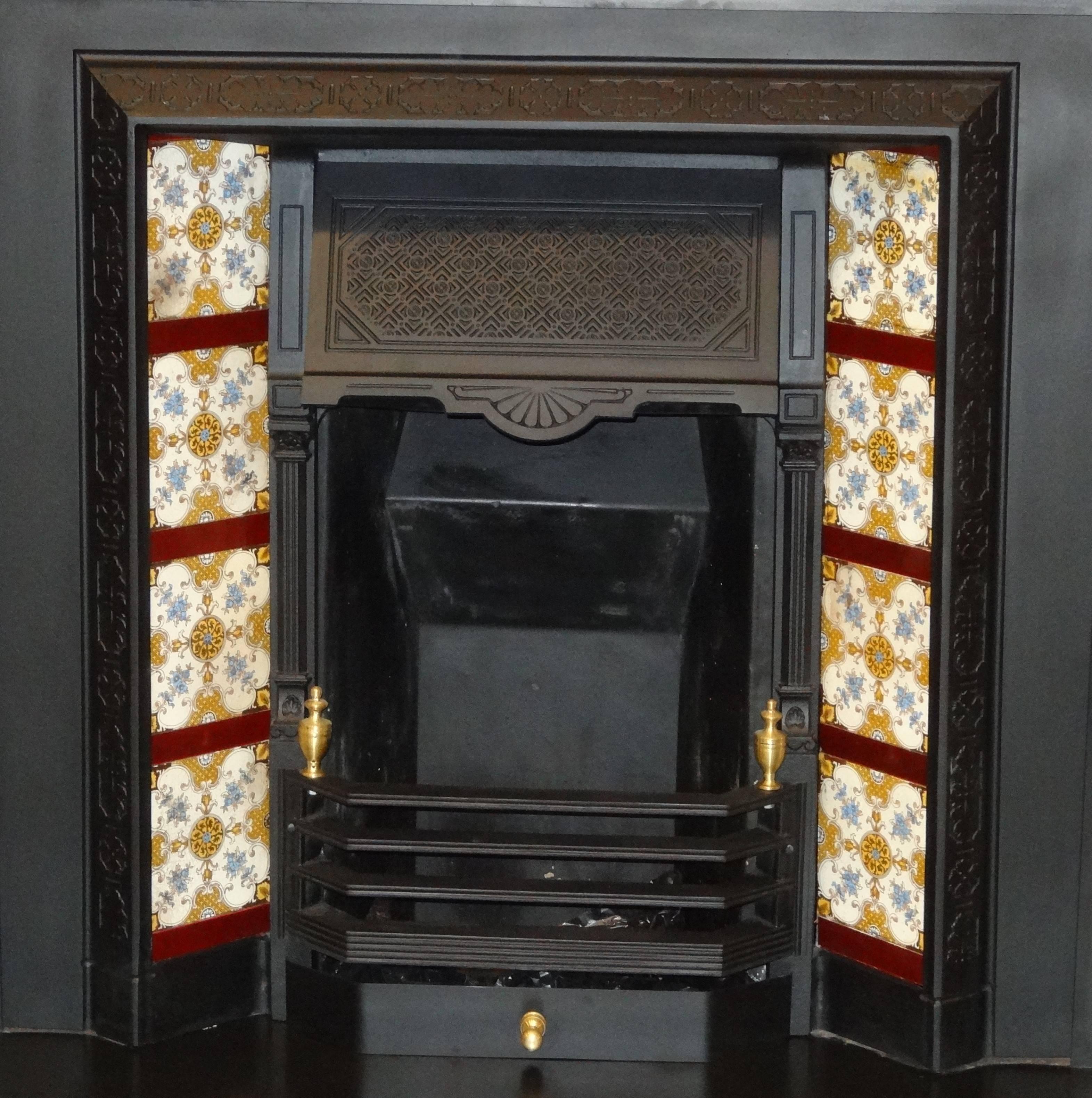 Reclaimed Irish 19th century Victorian cast iron fireplace insert grate with antique tiles.