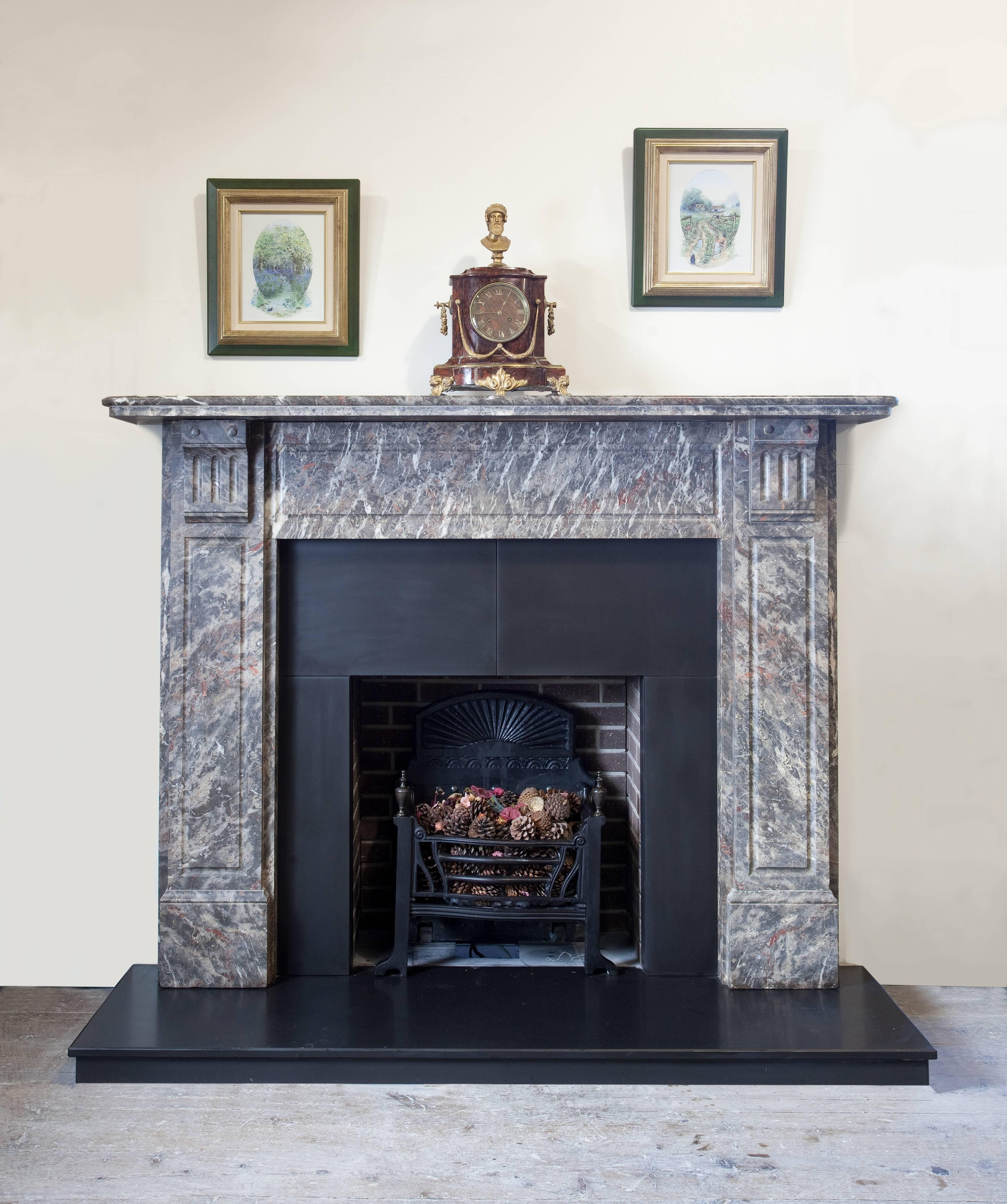 Antique Victorian hand-carved Breccia Pernice marble fireplace surround. Features fluted jambs and frieze, fluted corbels support two-tier mantel.

Approximate measurements:
Mantel width 66.75