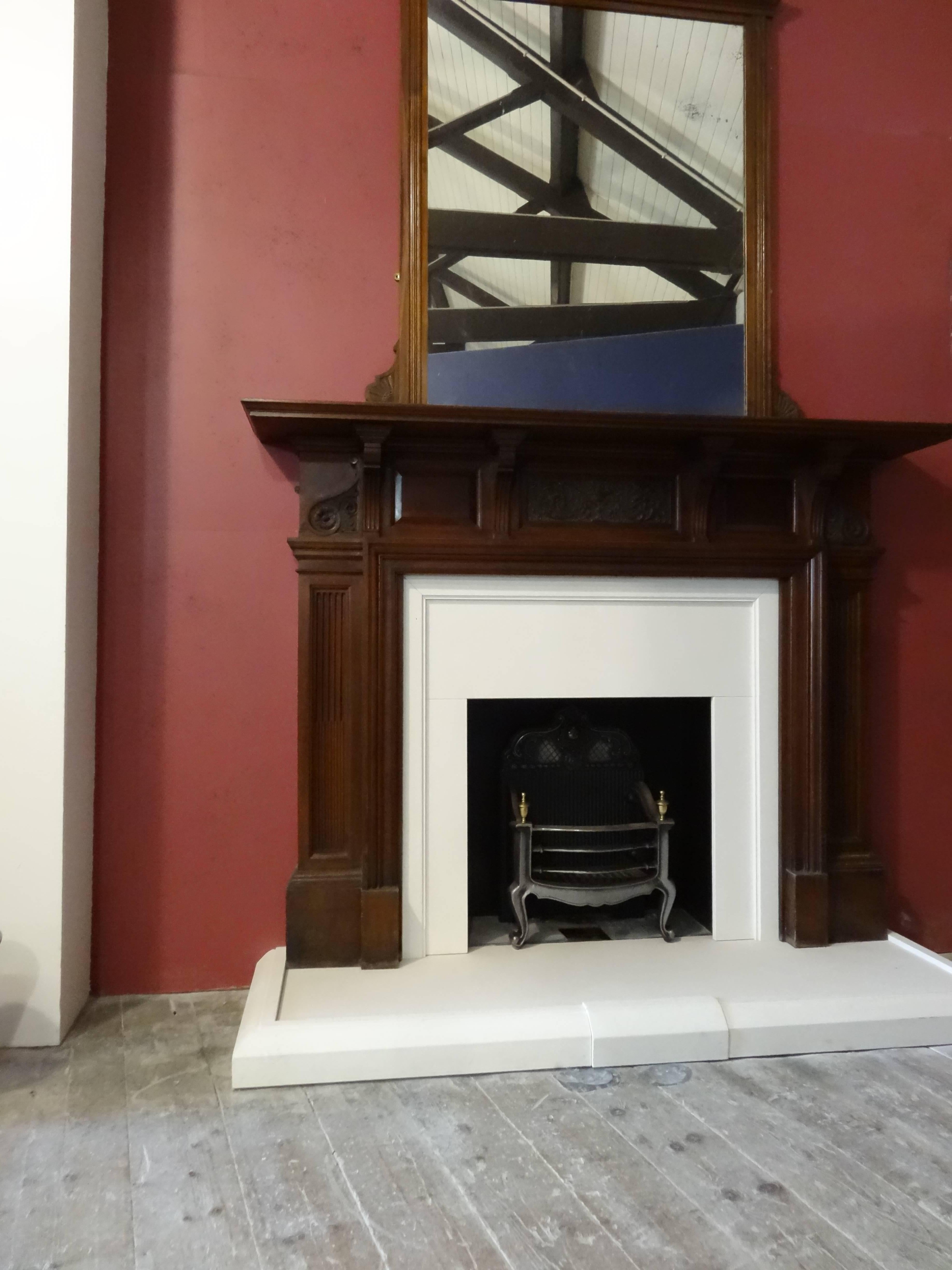 Reclaimed 20th century Edwardian hand-carved walnut fireplace surround with overmantel mirror. In original reclaimed condition.

External measurements:
Overall width 73 inches / 185 cm
Overall height 114 inches / 289 cm
Mantel depth 12.5 inches