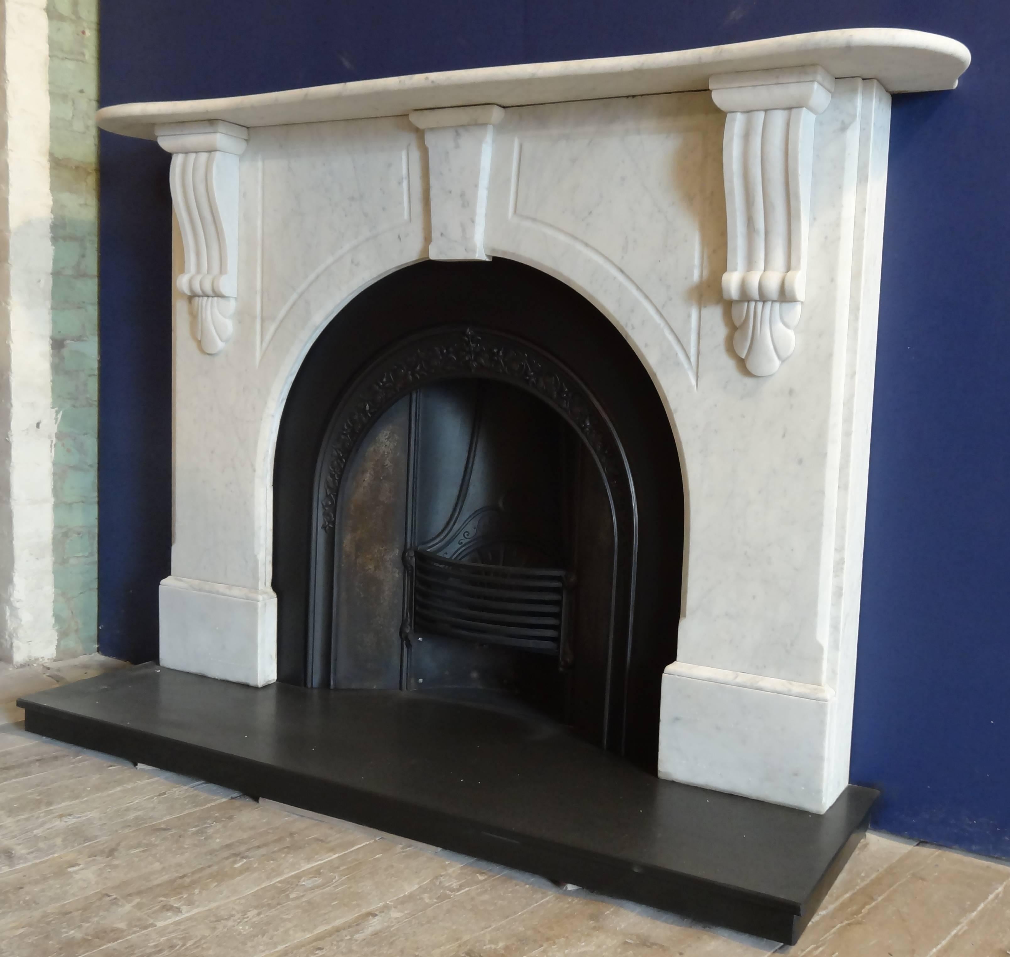 Antique Victorian white Carrara marble fireplace surround. The fireplace has an arched aperture, fluted corbels and panels, centre keystone and serpentine mantel. Reclaimed from a Victorian property in county Antrim Northern Ireland.
Cast Iron