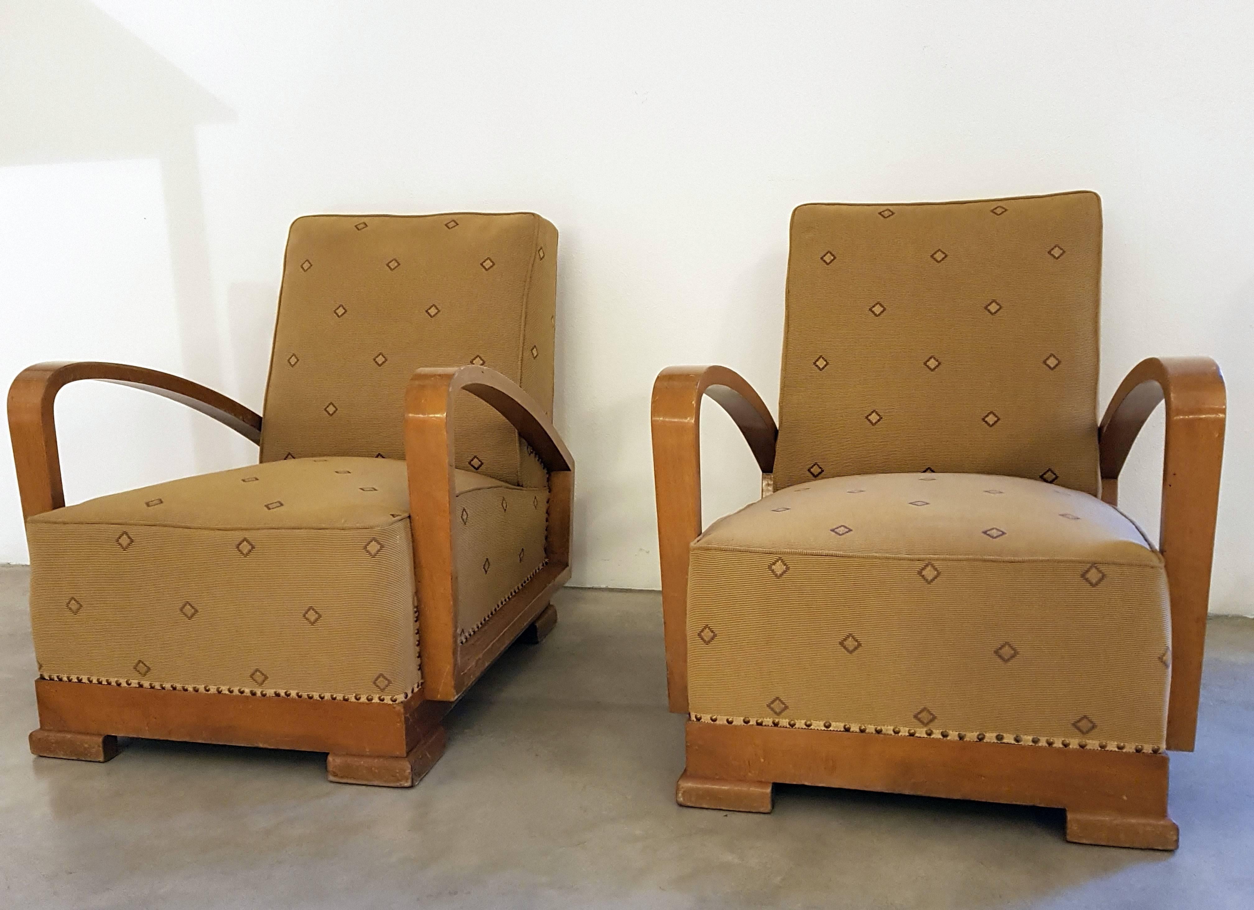 A pair of Art Deco armchairs produced in Italy in the 1930s. Clear and flexible lines, fine crafted are the main features of these armchairs which have been reupholstered in fabric made by Sahco Hesslein company. The armchairs are in very good