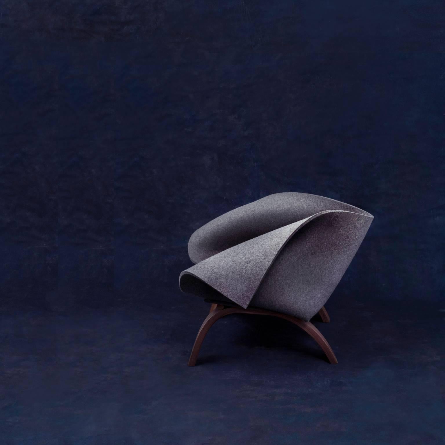 Babafelt is an easy chair made from thick natural wool felt. The felt sheet is cut and folded to make a cocoon-like space in which to sit, which responds to the occupants’ movements and hugs them as they lean back.
The wooden frame is made by