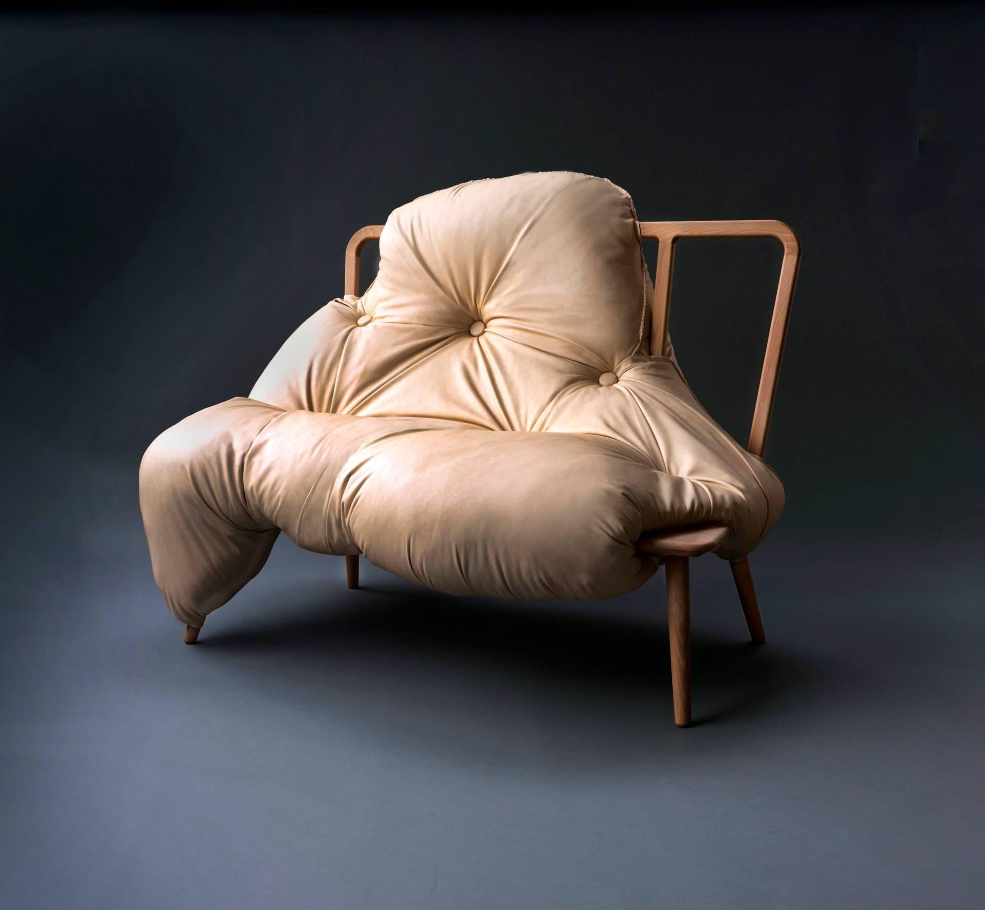 My Big Fat sofa narrates the bond between a female figure and her sofa. Together they sit as one, the upholstery spills and bulges, enveloping the wooden frame as a marriage of two mediums. The biomorphic seat is unsettling and inviting both at