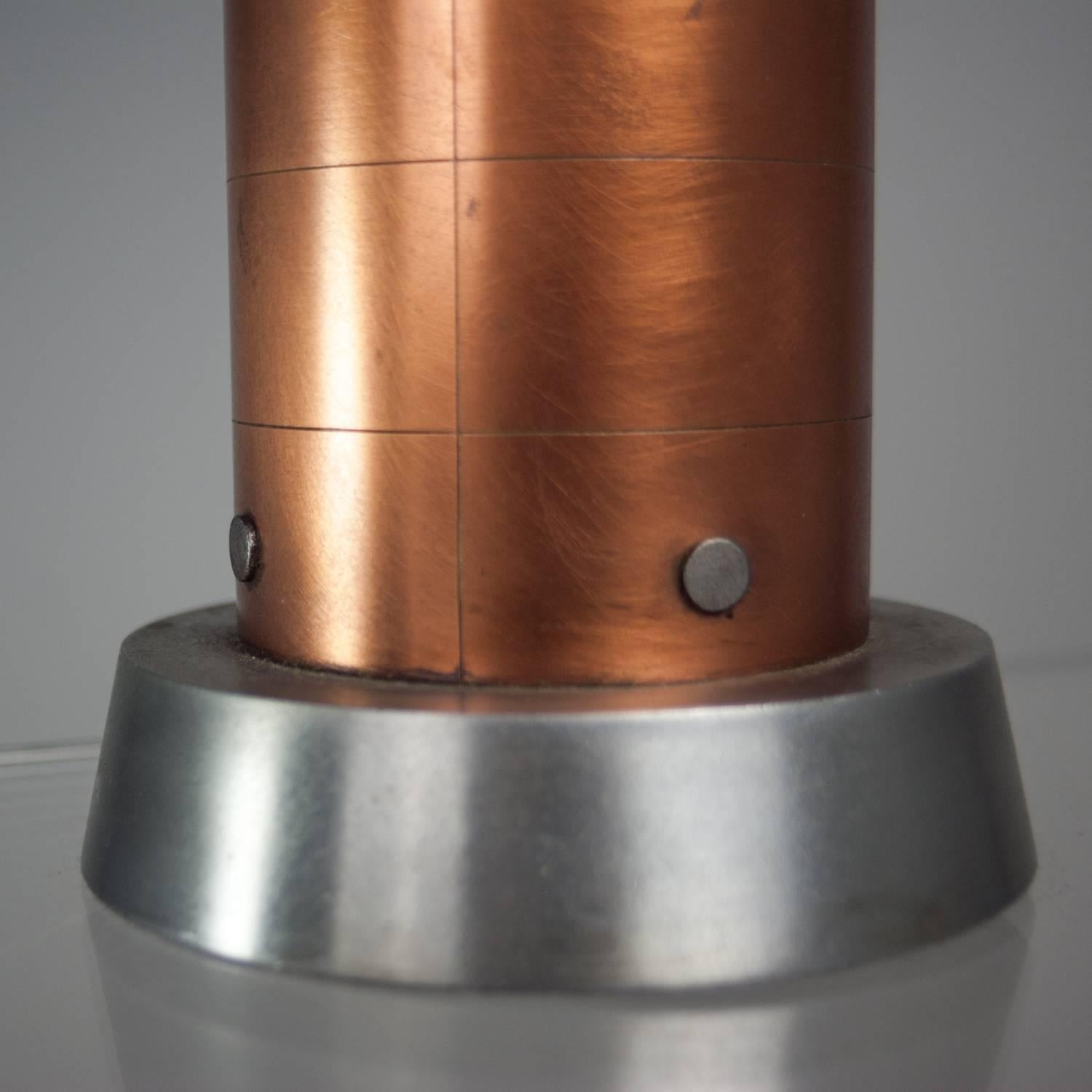 Spun copper and stainless steel Machine Age table lamp. Professionally rewired with black cloth cord, new ivory linen drum shade.