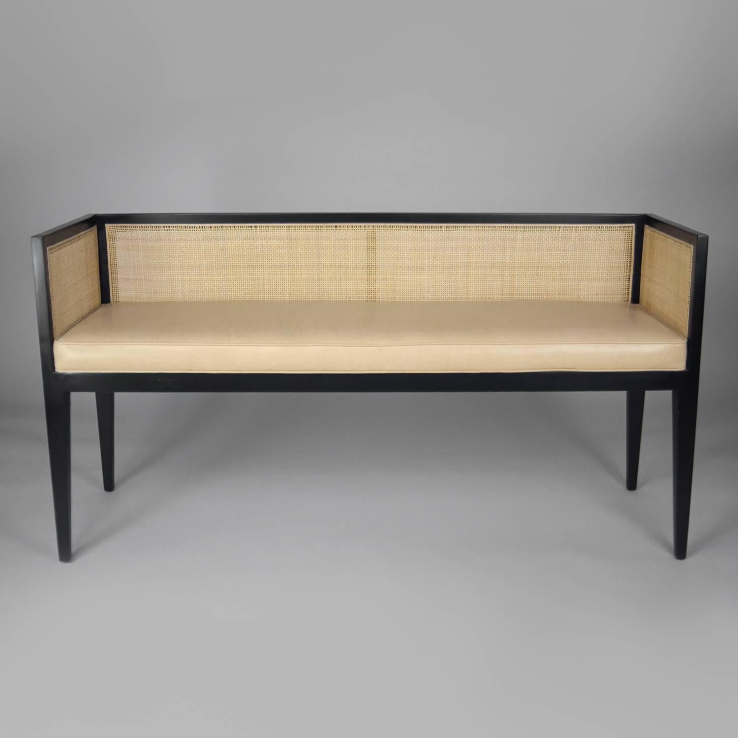 Midcentury bench with new natural caned back. Bench has been professionally refinished to an ebony frame with a tight ivory leather seat.