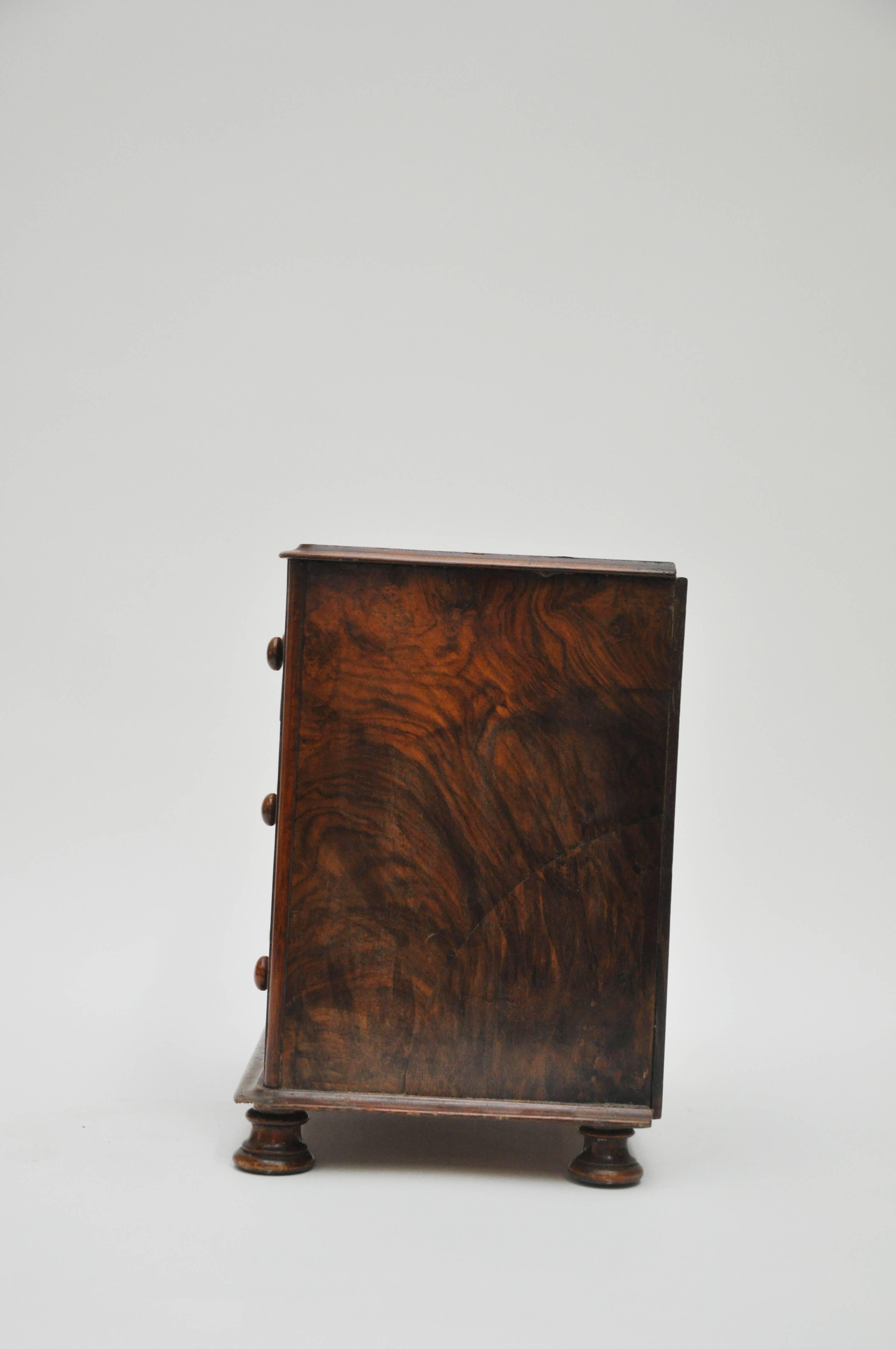 This mahogany burl three-drawer salesman sample chest was used by salesman as a visual aid to help make sales during the late 1800 and early 1900s.
