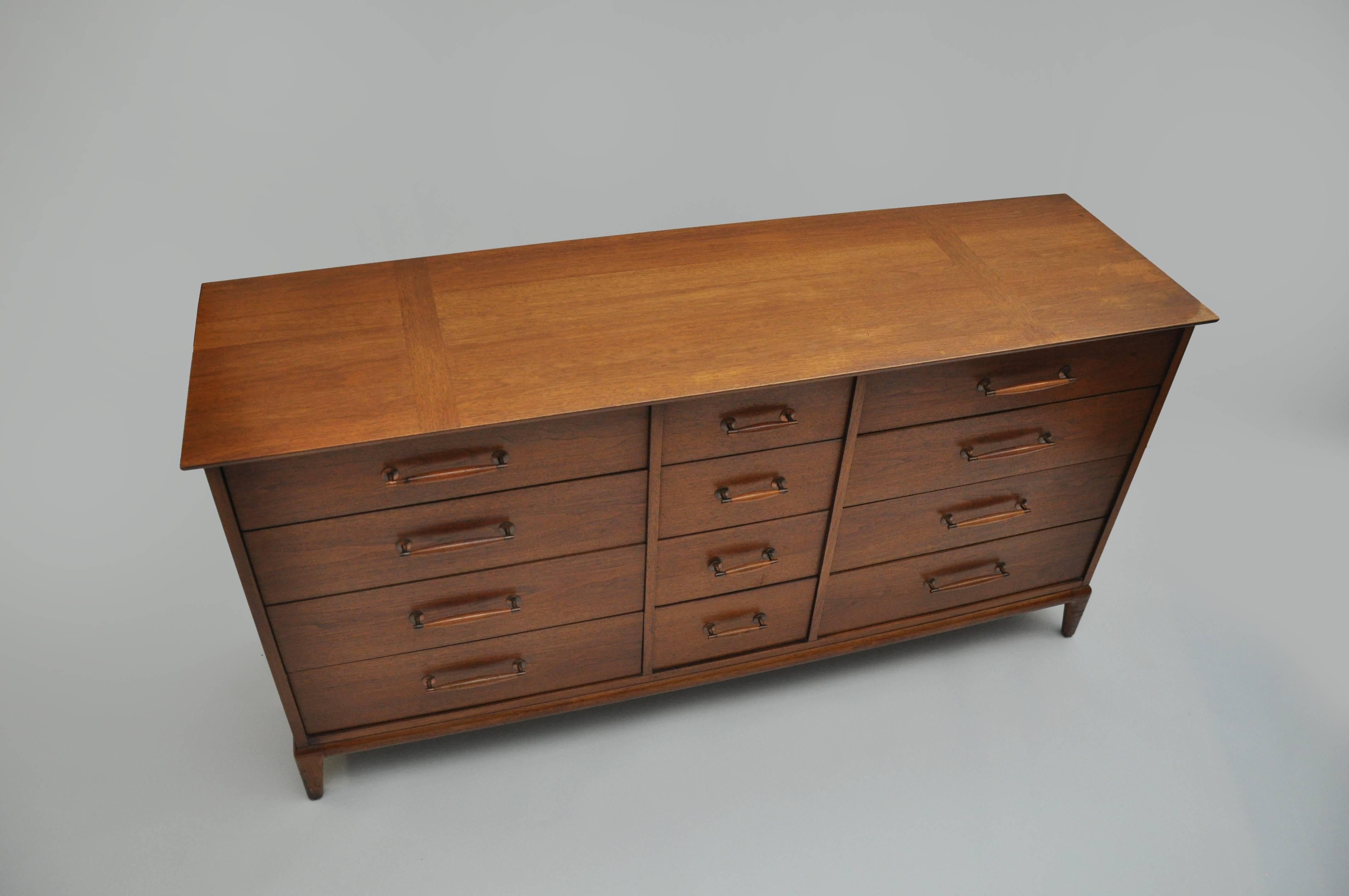 Mid-Century chest with copper and wood hardware. Chest is of walnut and has 12 drawers. Original brochure is in image three. Could be used as a credenza.