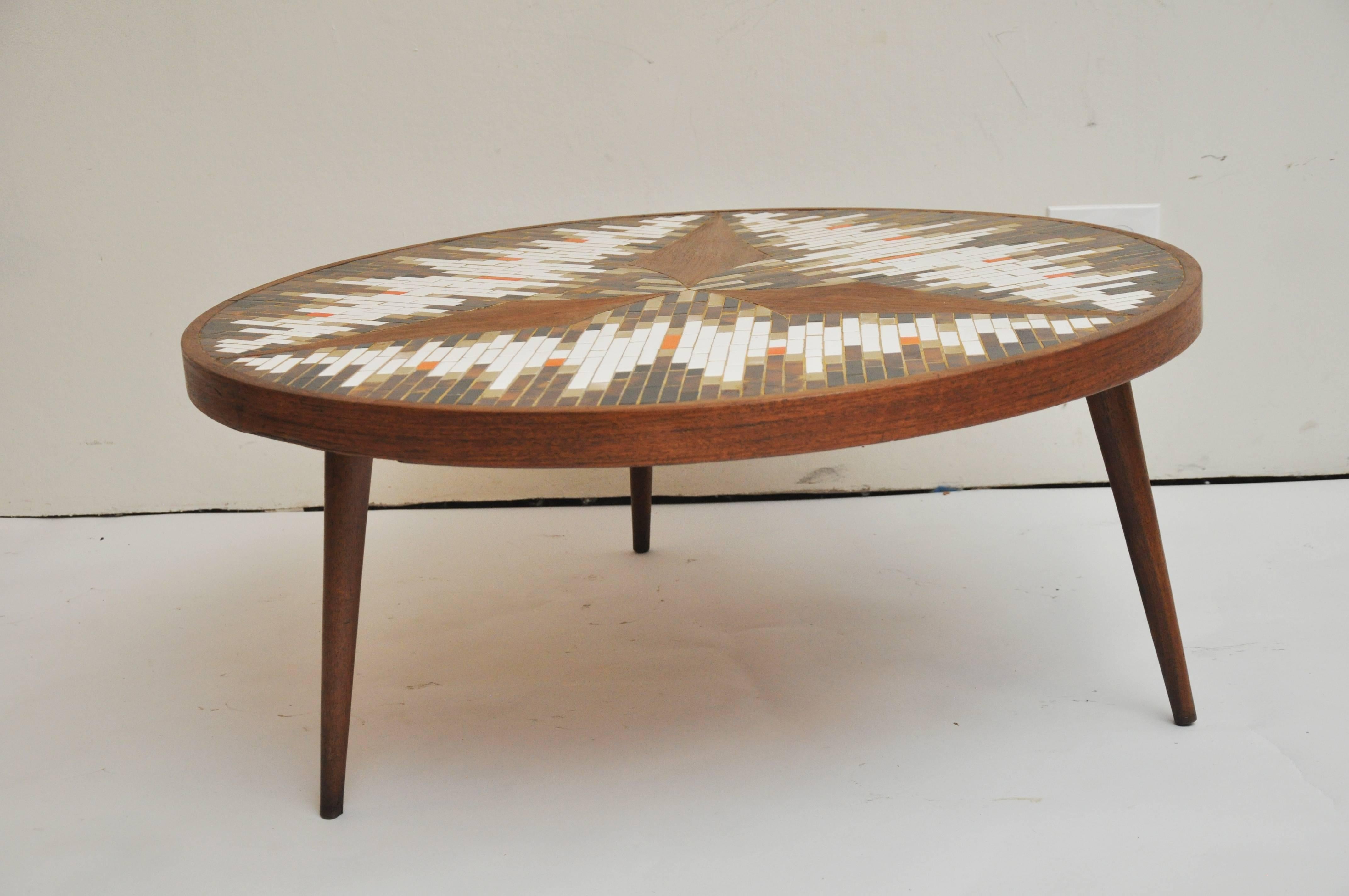 Circular Mid-Century Modern coffee table by Richard Hohenberg. Table is made of teak wood and ceramic tile. Each of his has a unique design.