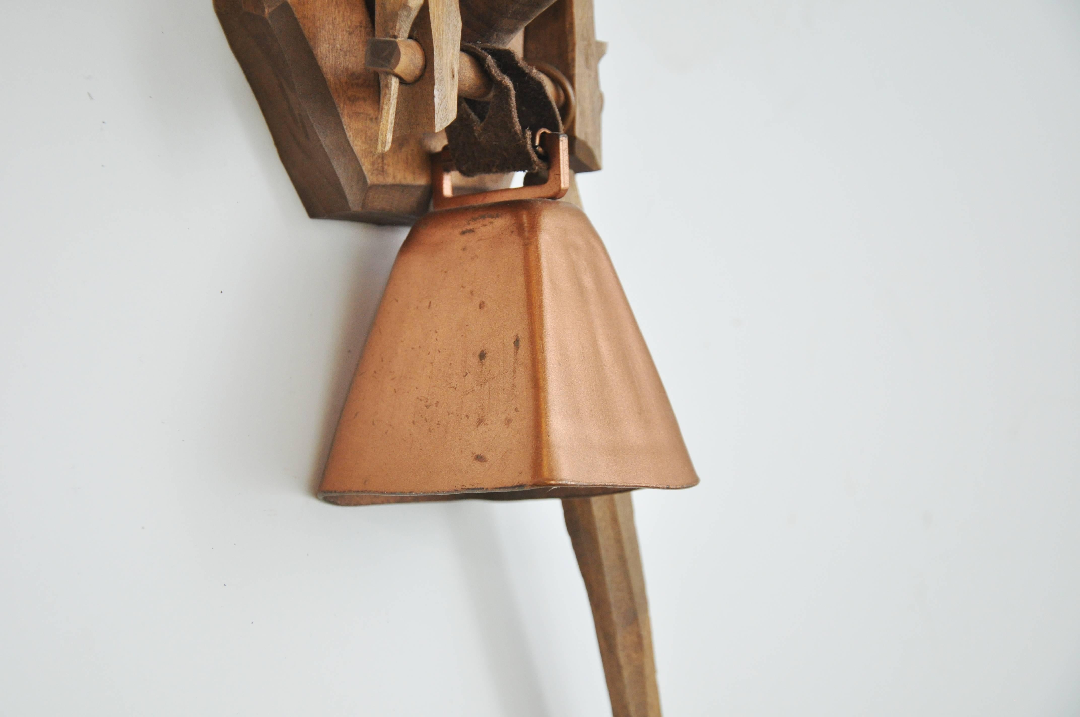 Unusual wall-mounted, hand-carved wooden piece includes attached copper bell and hammer.