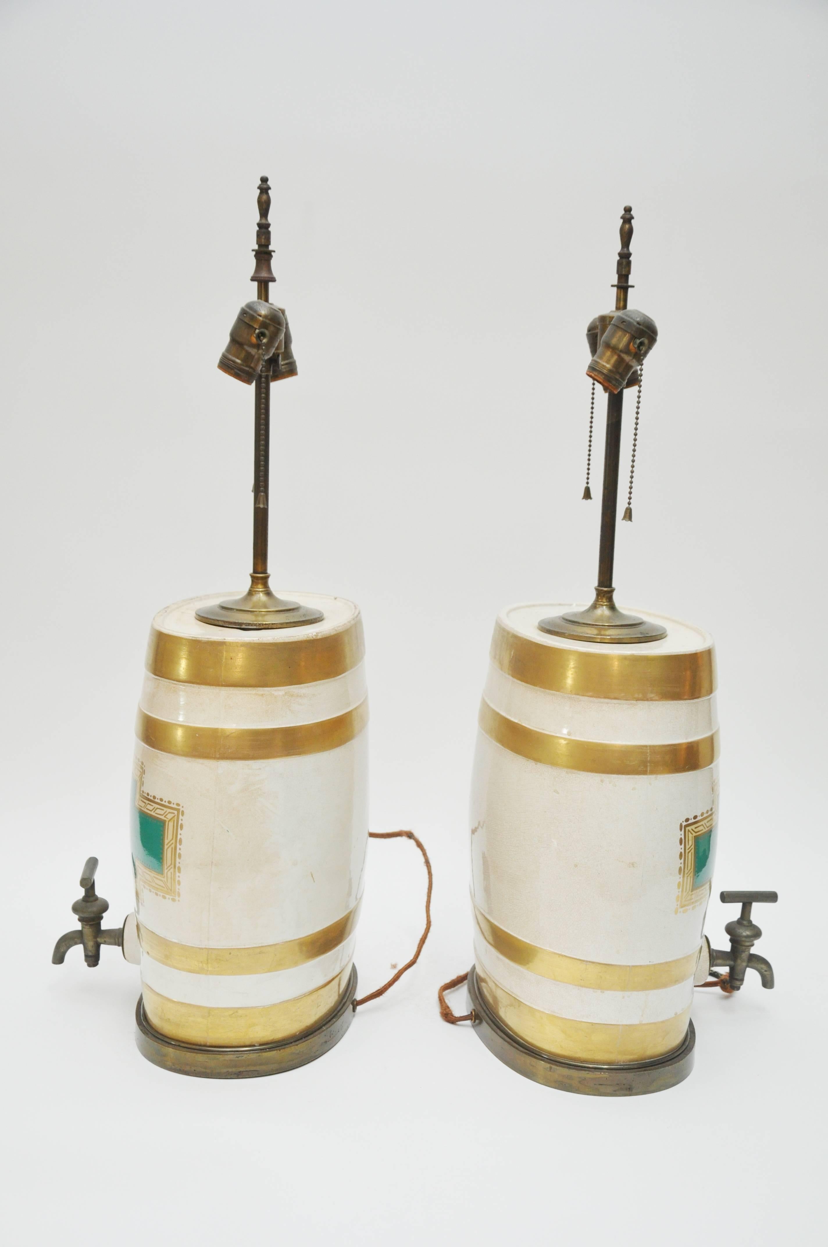 Pair of colorful oval ceramic jug lamps with brass spigot. Transfer ware and gilded decoration.