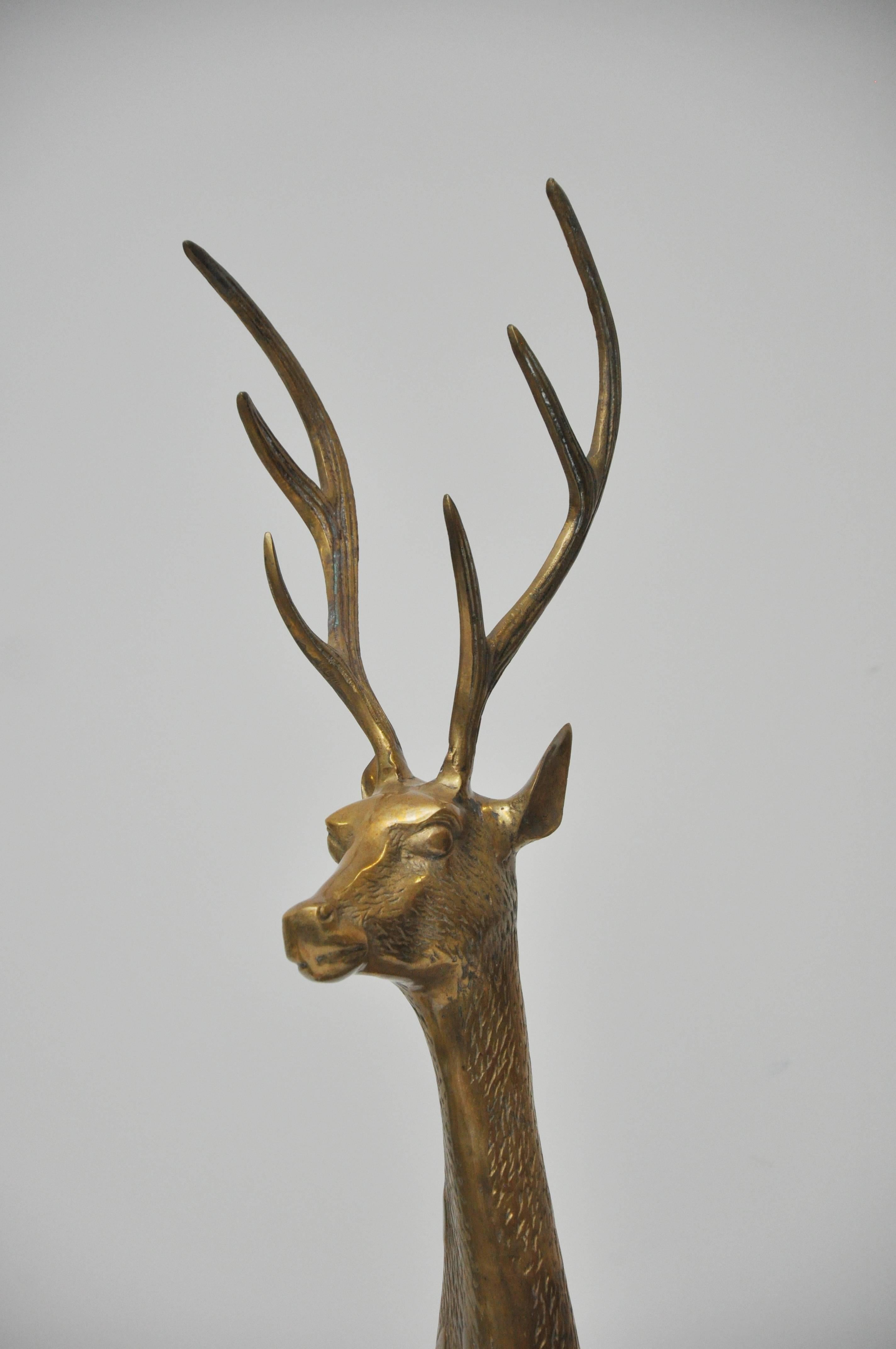 Very large Mid-Century brass deer, set of three including buck, doe, and fawn. The brass figures have detailing of the fur. Beautiful patina. Measures: Buck stands 50