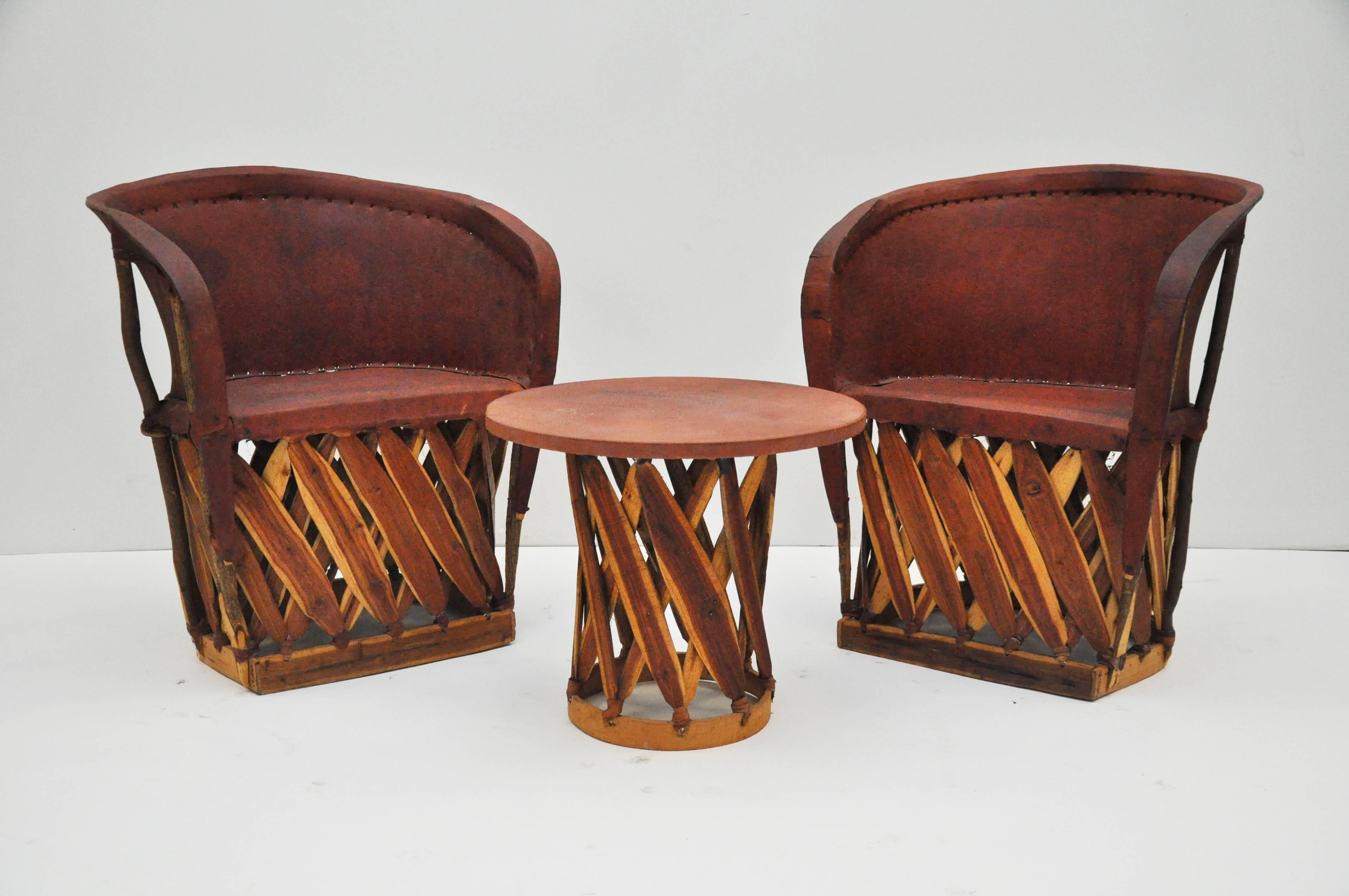 Handmade set of chairs and table are made from tanned pigskin and cedar strips. 
Table measures 20.5 
