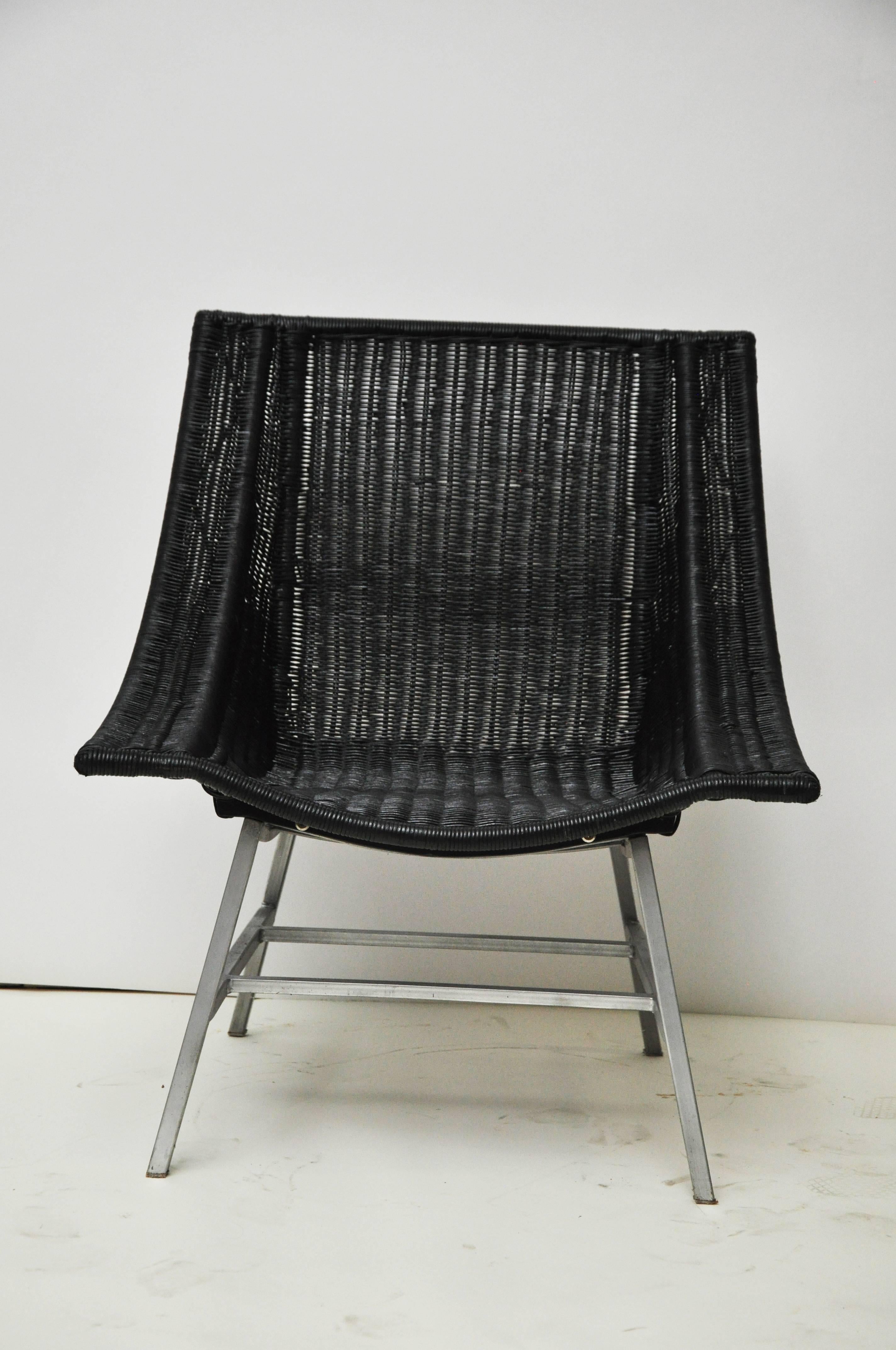 Wicker Mid-Century Modern chair with stainless legs has been newly sprayed. The original color was black as well. The wicker is in good condition. Lines of the chair make it modern.