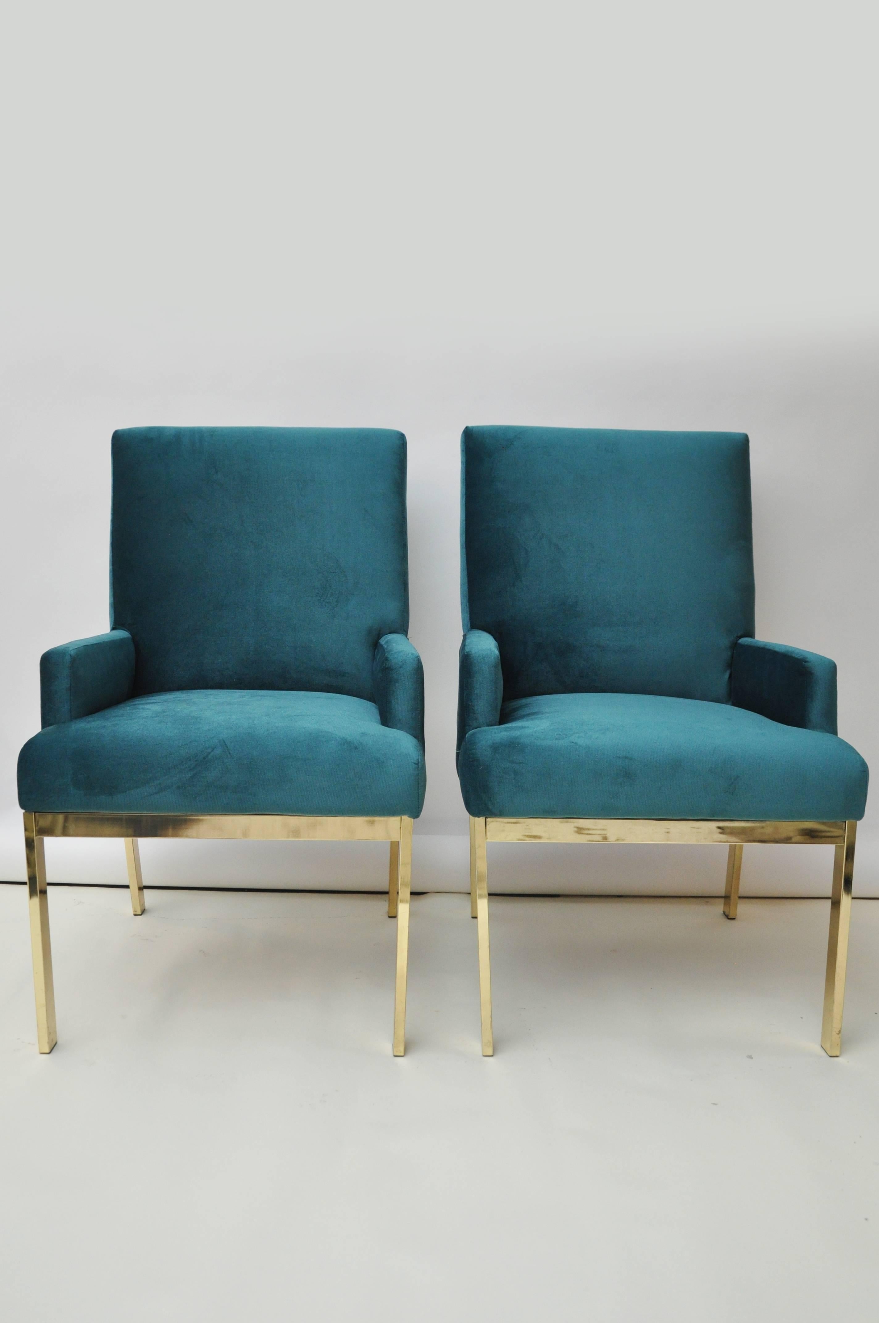 Set of four Design Institute of America dining chairs. There are two armchairs and two armless chairs. Chairs have a brass base and have been newly upholstered in velvet. Arm height on armchair is 23.5