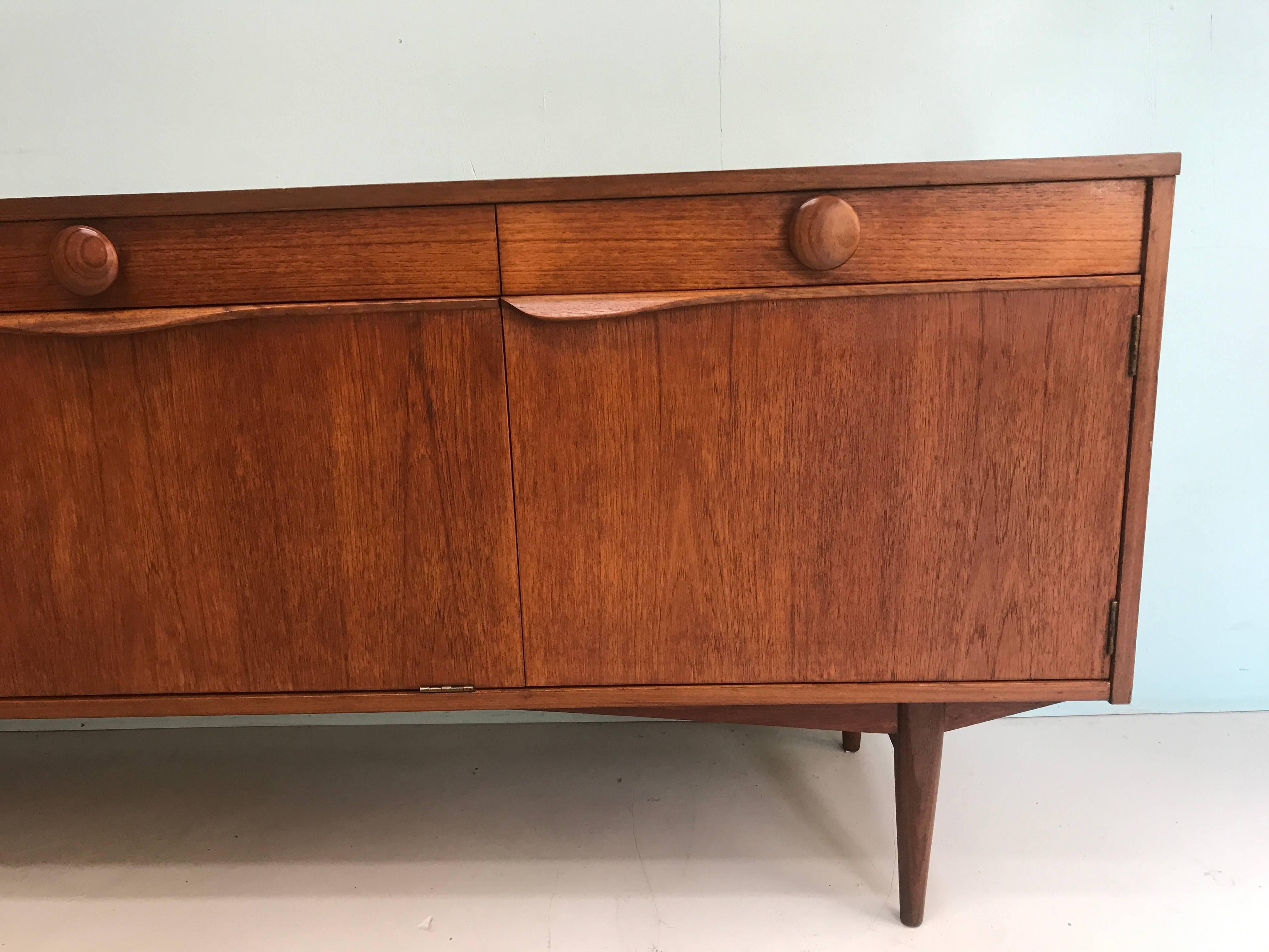Vintage sideboard made of teak from the 1960s, England produced by Elliot in England.