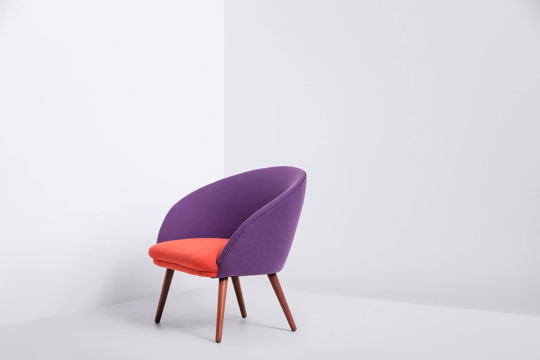Danish produced cocktail chair from the 1950s in orange & purple wool upholstery from Danish Kvardat Textiles.
The legs of solid teak and in a good condition with minor wear, consistent with age and use, preserving a wonderful patina.
Dimensions: