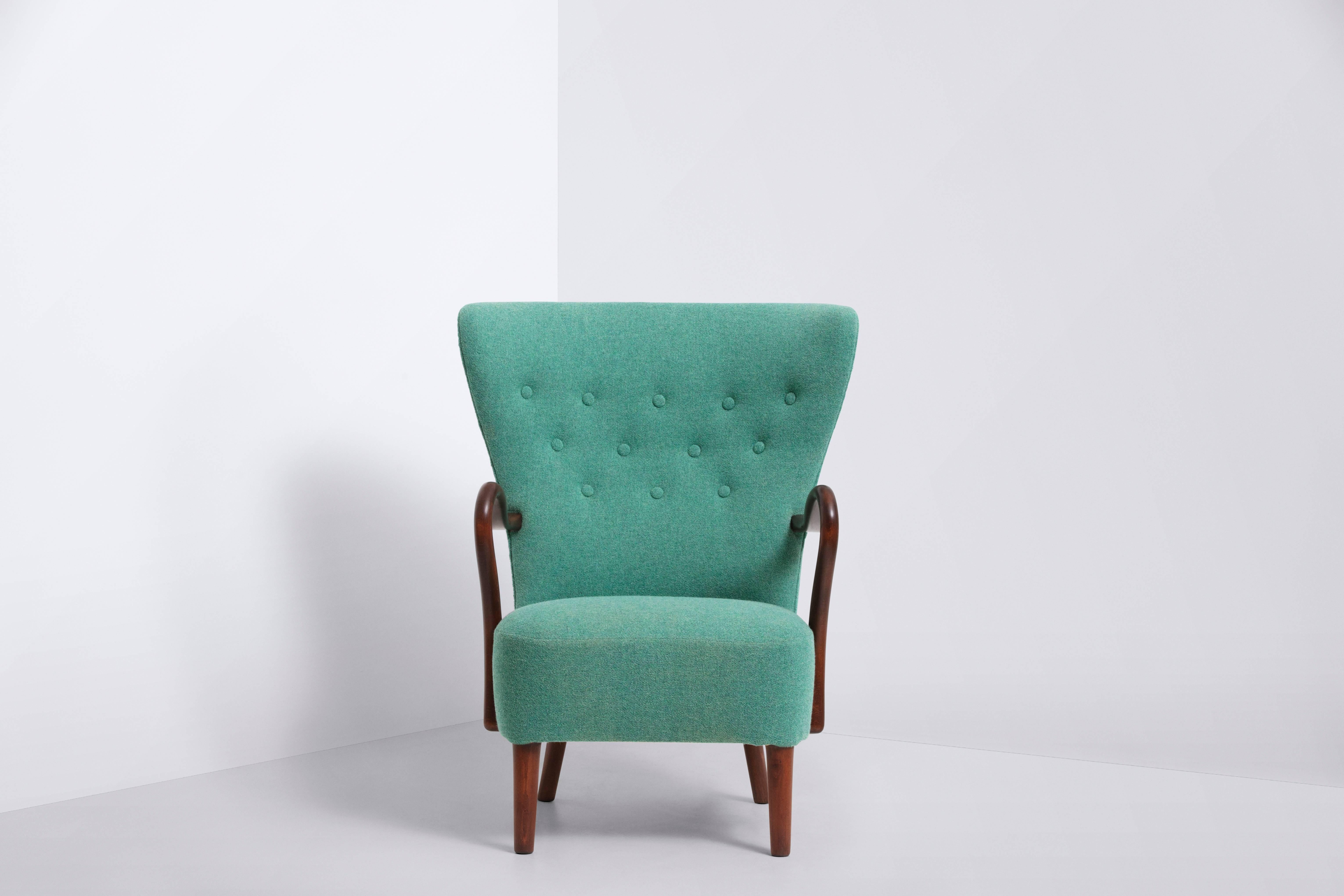 Frame and armrests of solid teak
Turquoise wool upholstery by Kvadrat.
   