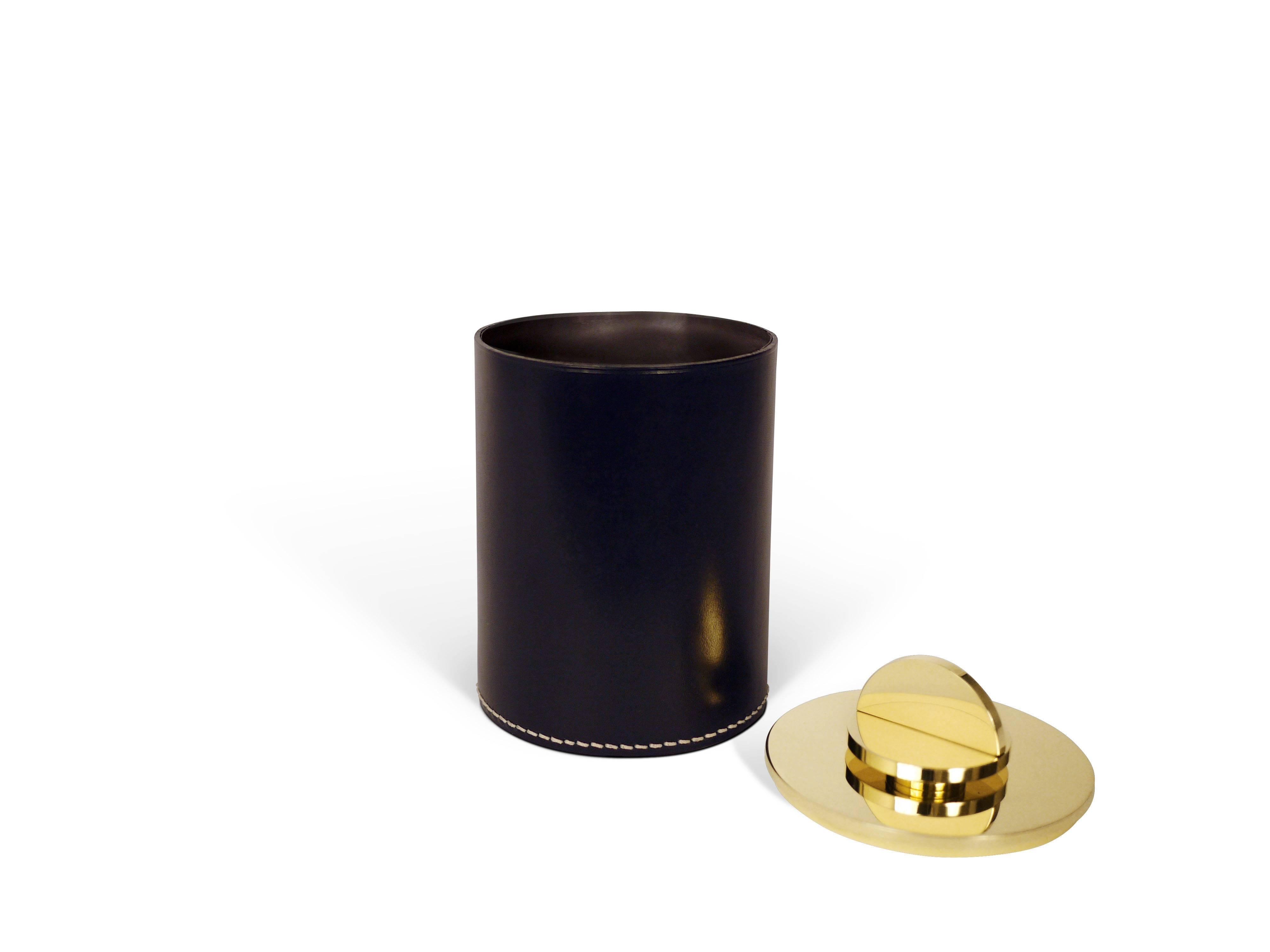 Part of Les Few's Armance collection, this contemporary black round leather and brass modern minimalist box is made by artisans in Sweden. The interior leather comes in either anthracite grey or white. The brass is solid Swedish brass and the