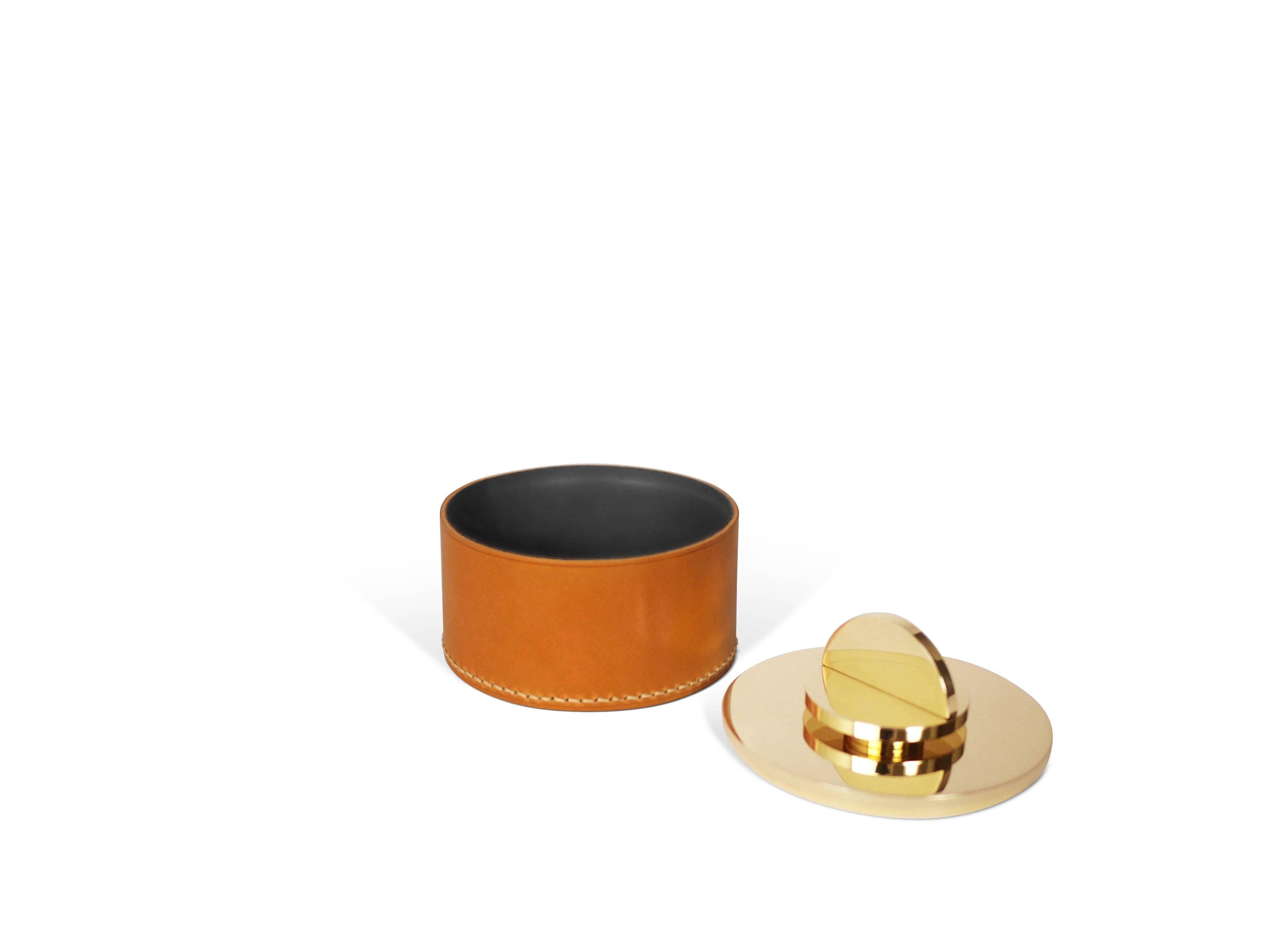 Part of Les Few's Armance collection, this contemporary, cognac colored, round, leather and brass, modern, Minimalist box is made by artisans in Sweden. The interior leather comes in either anthracite grey or navy. The brass is solid Swedish brass