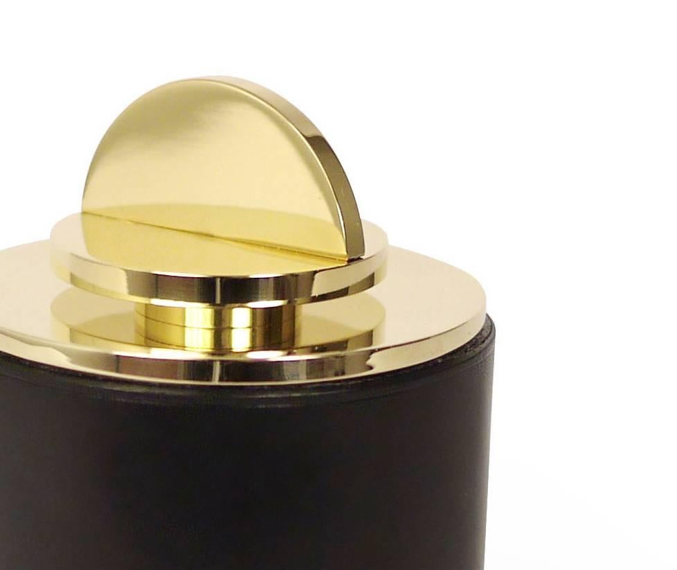 Part of Les Few's Armance collection, this contemporary, black, round, leather and brass, modern, Minimalist box is made by artisans in Sweden. The interior leather comes in anthracite grey. The brass is solid Swedish brass and the Italian leather