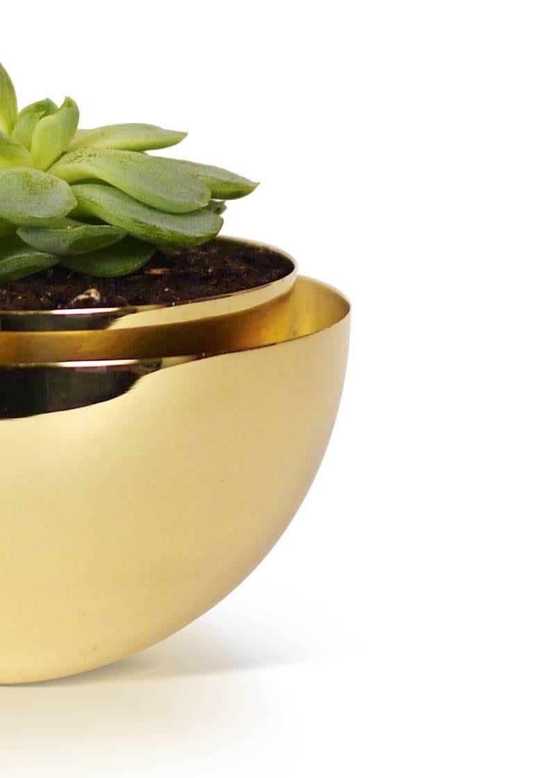 Part of Les Few's Armance collection, this contemporary, round, Swedish brass modern, Minimalist planter is made by artisans in Sweden. The planter features two bowls, an inner and an outer. The brass is Swedish brass that is handspun to the shape