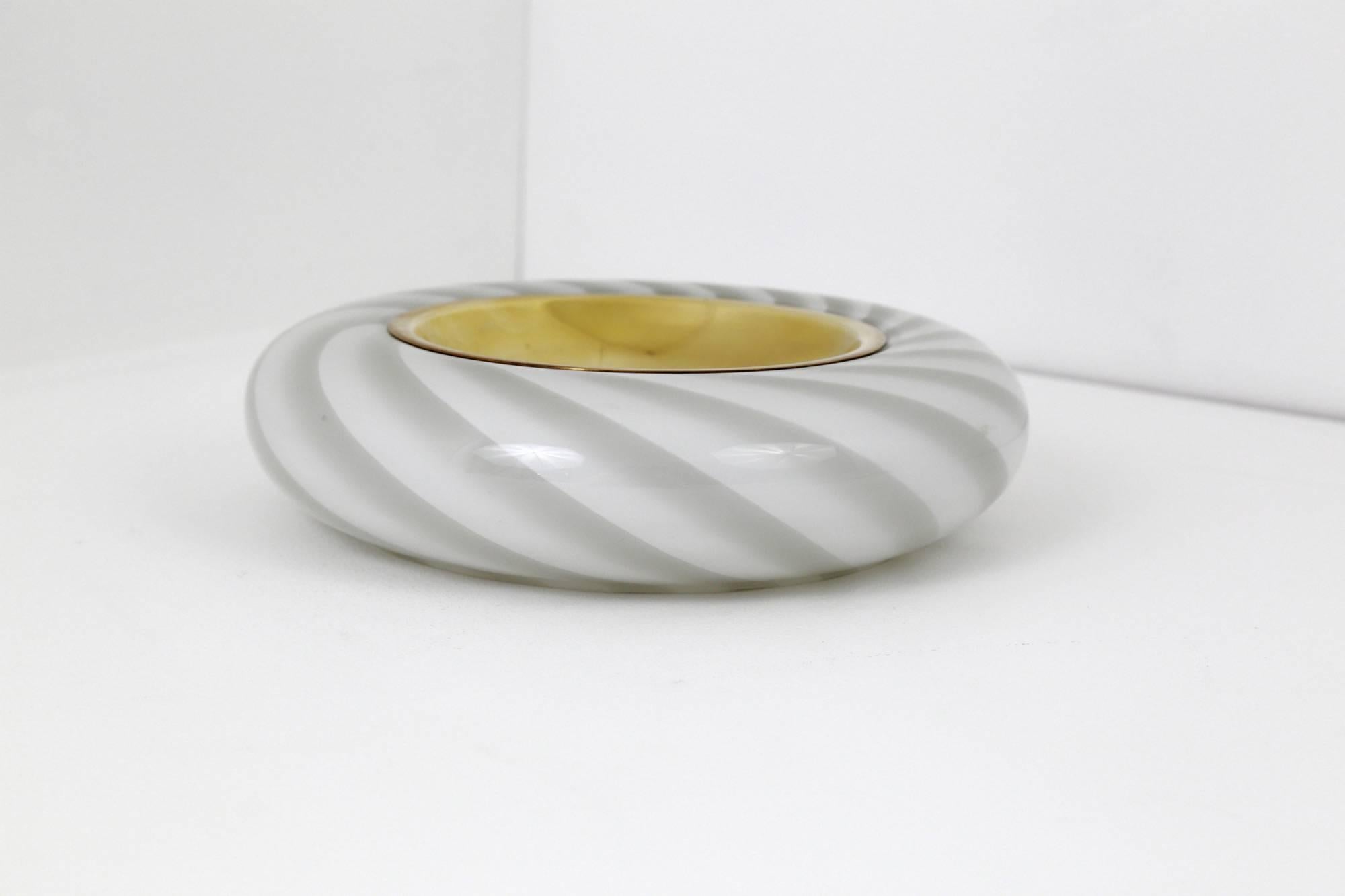 A wonderful, white and grey, Murano glass bowl with a polished brass insert at its centre. Designed by Tommaso Barbi, during the 1970s, it is signed 'TB/Made in Italy' on the underside.