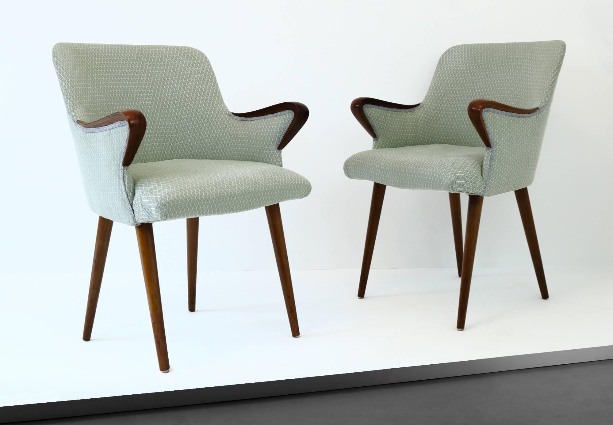 A fantastic pair of P38 chairs in beech, upholstered in a patterned, pastel green, vintage fabric. Designed by Borsani in 1953 for Techno, the P38 chair features beautifully curved armrests that seem to protrude from within the frame. The seat