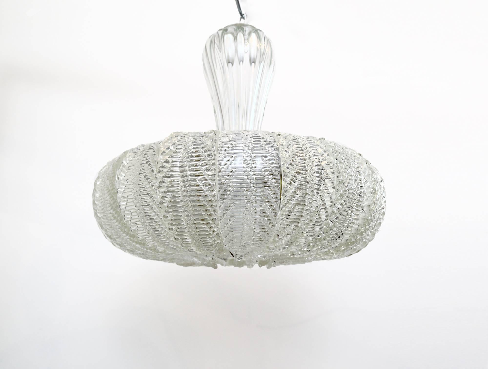 An exquisite, circa 1940s glass ceiling pendant by the famed Murano glass manufacturers, Barovier and Toso (attrib.) The internal three light fitting is encased within 20, handblown, curved glass leaves, whilst the glass diffuser plate underneath is