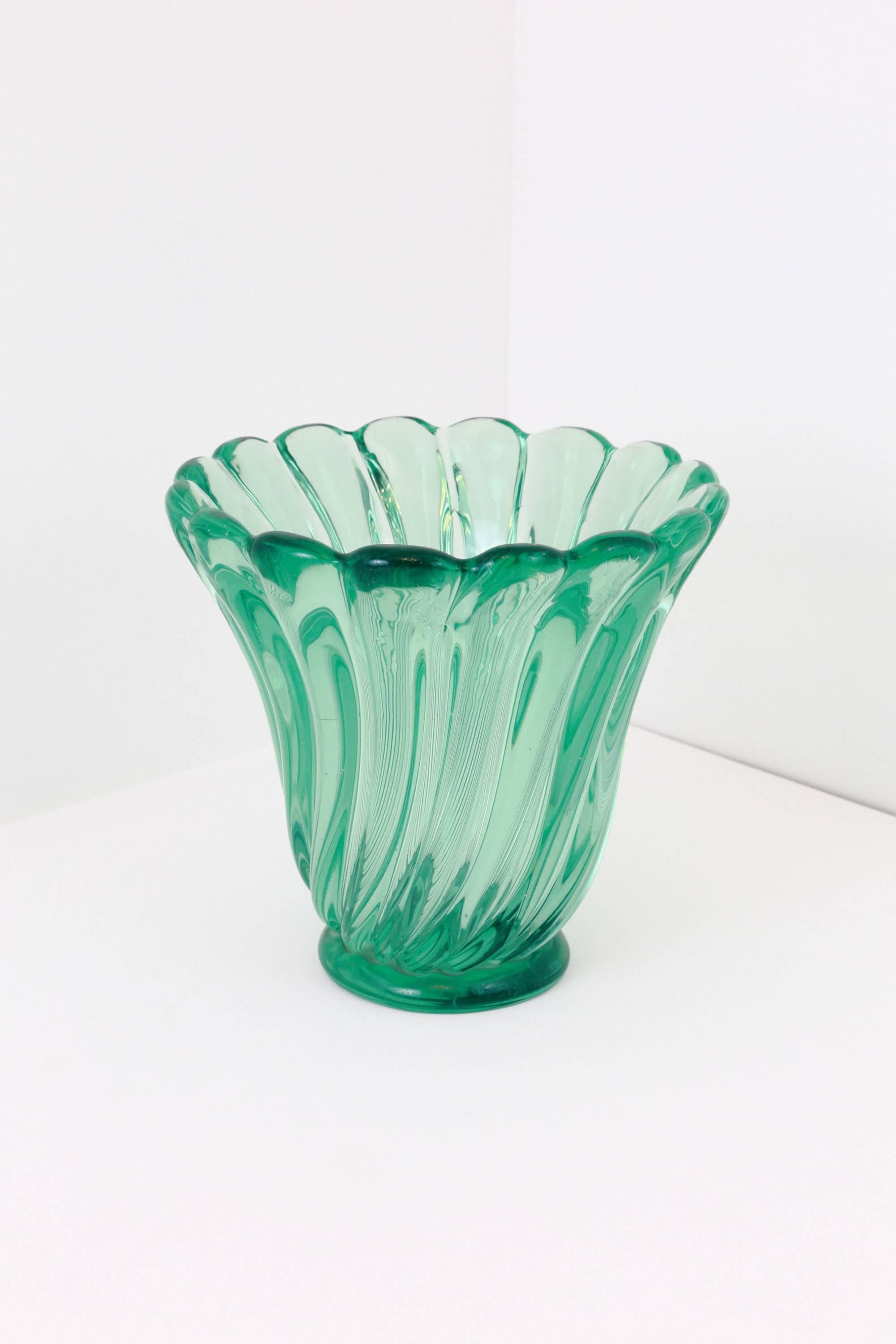 An amazing piece of Murano craftsmanship, this large and very heavy emerald green vase was produced by Seguso in the 1950s. The vase features a wonderful 'swirl' pattern which captures the light beautifully giving it movement. The color and clarity