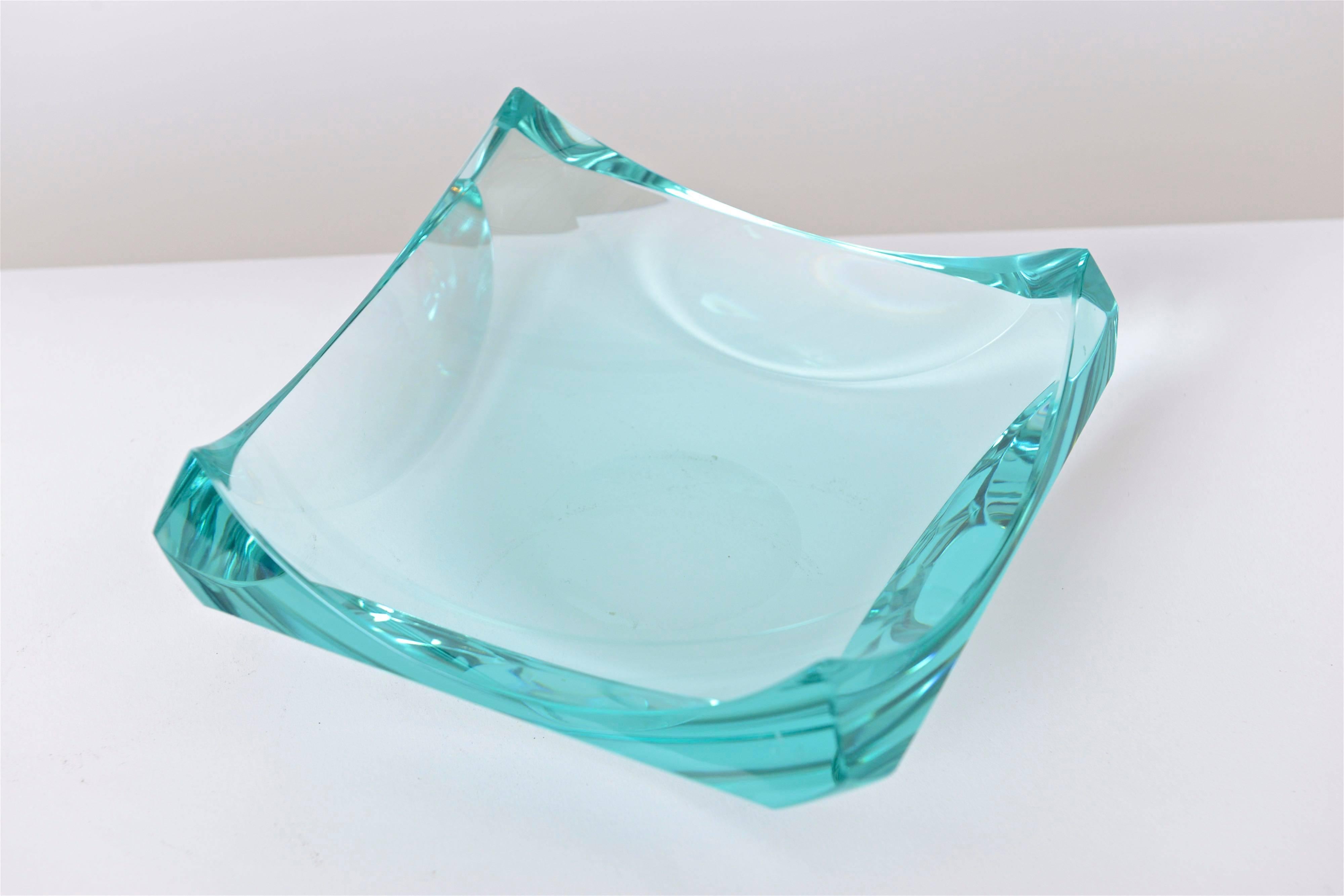 A superb aquamarine crystal dish or vide-poche designed by Erwin Walter Burger for Fontana Arte, circa 1960. Square in shape, the dish has beautiful uplifting corners which accentuate the gorgeous color and clarity of the glass. Signed 'EB' in the