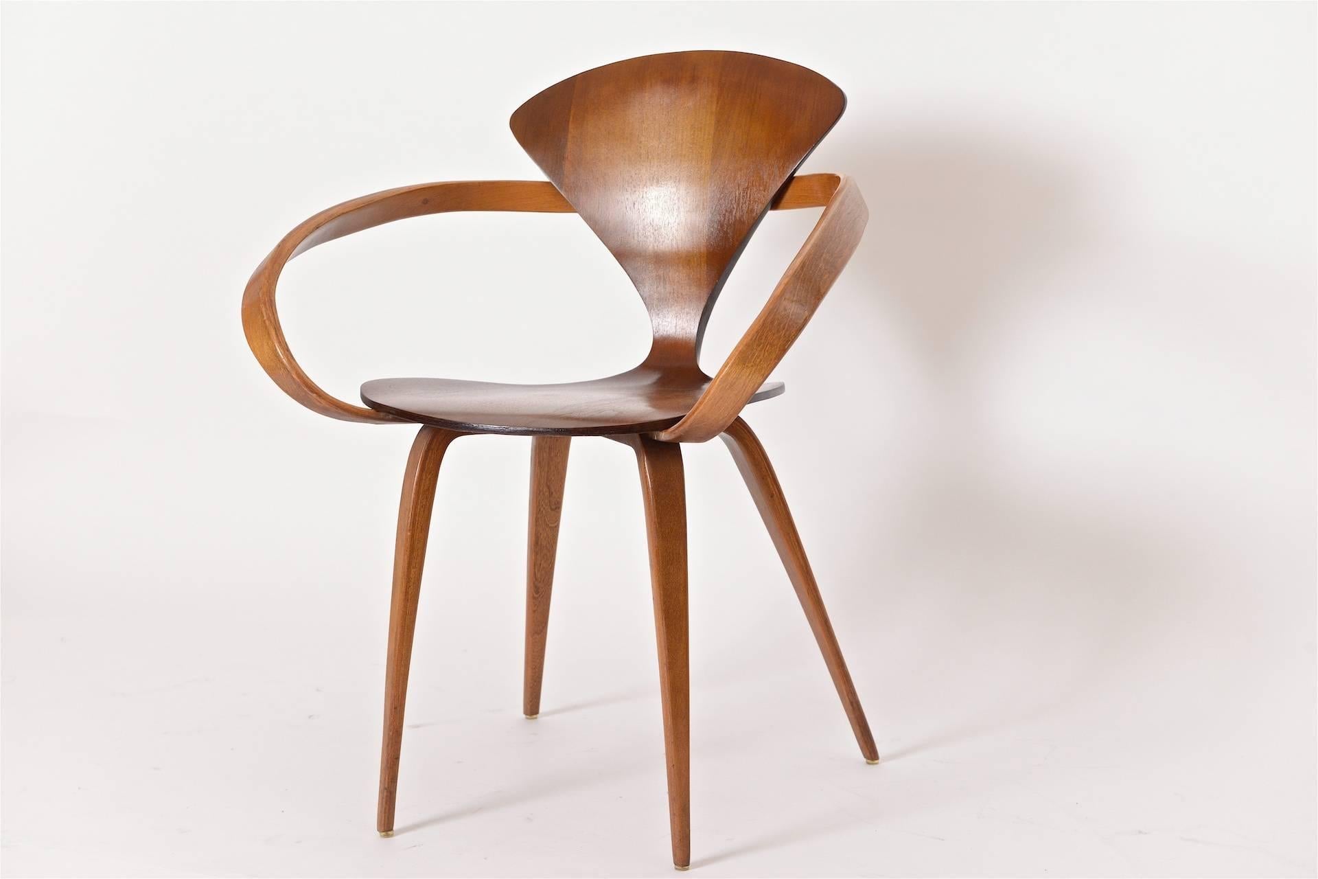 A beautifully curvaceous walnut armchair by American designer, Norman Cherner. The Cherner Chair was originally designed in 1957 and produced by a Massachusetts based company, Plycraft. This model is a rare, early version from that same company. In