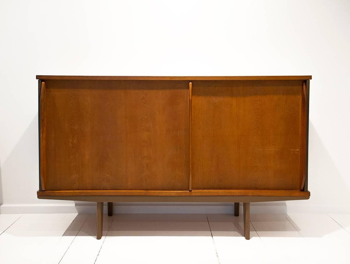 'Bahut' cabinet designed by Jean Prouvé. Made of solid oak and plywood doors in bent sheet steel. 
circa 1950, France.
 