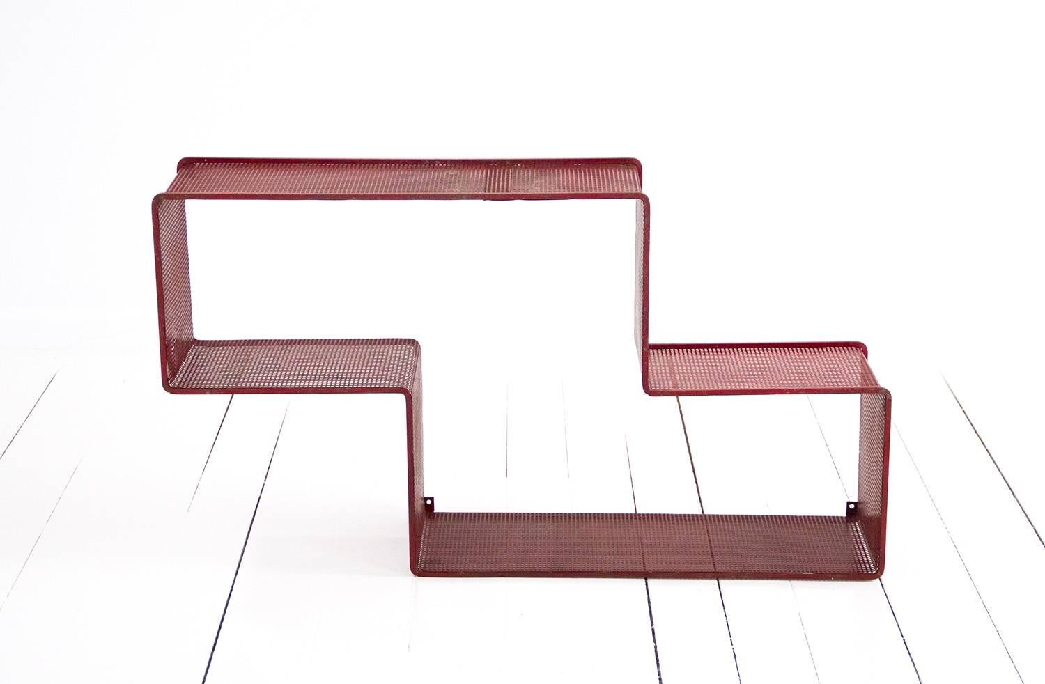 Red 'Dedal' wall shelf designed by Mathieu Matégot.
Made of perforated steel. Preserving the original patina. 
France, circa 1950. Manufactured in France by Ateliers Matégot.
  