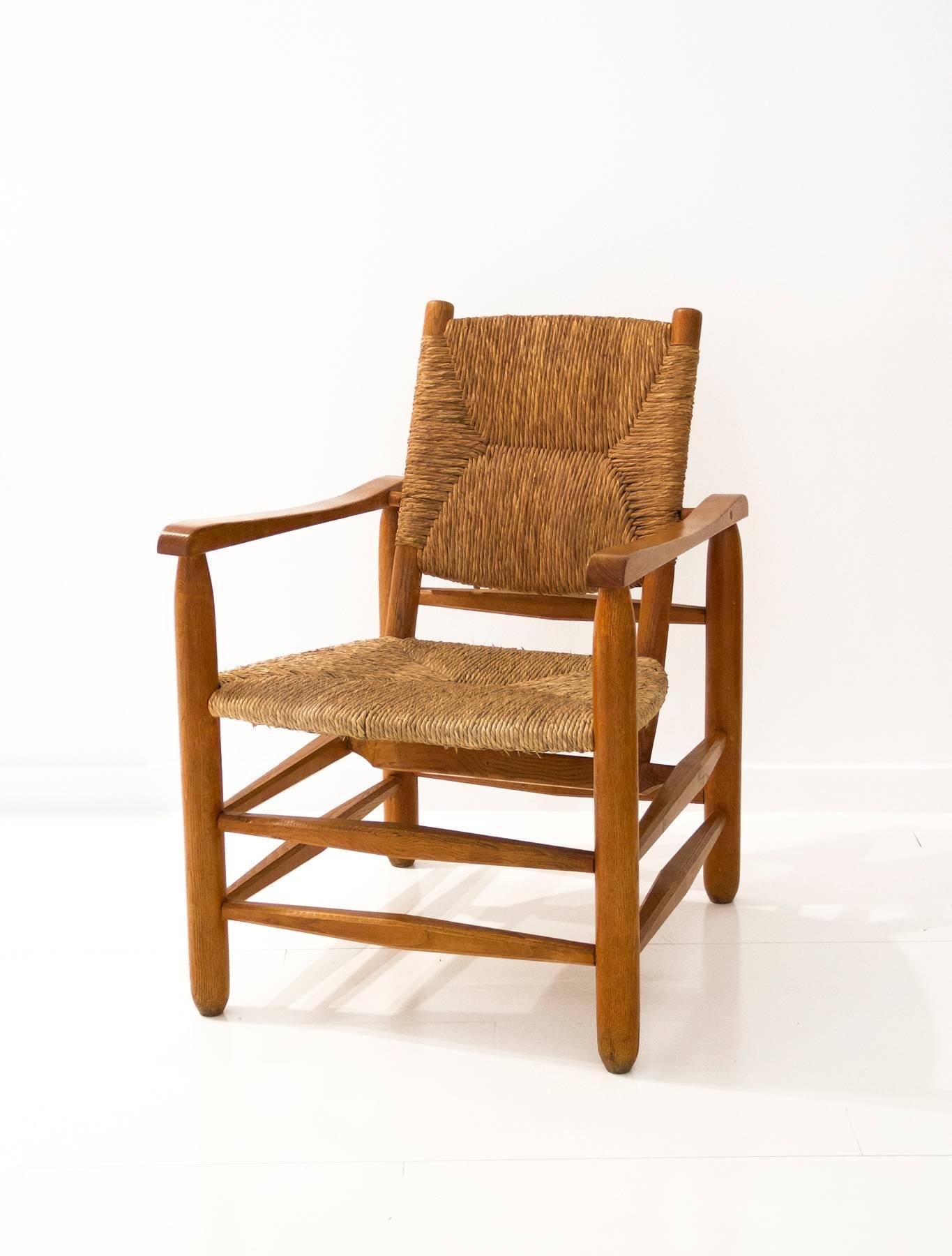 “Paillé” armchair designed by Charlotte Perriand. Solid wood structure, seat and back in straw fabric,
circa 1935, France.
 