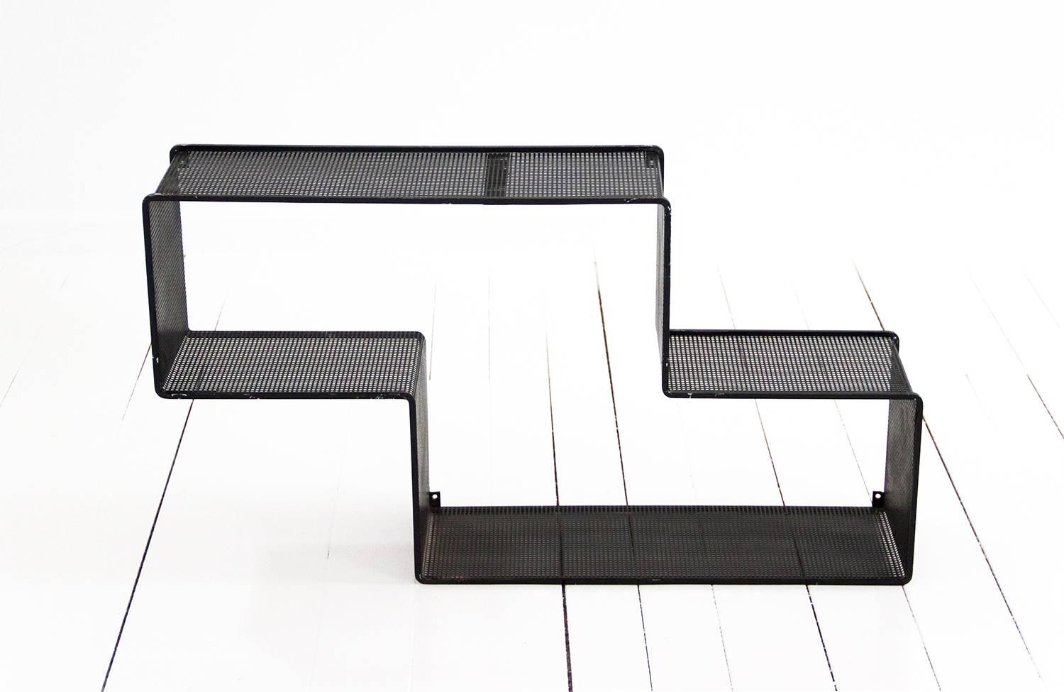 Black 'Dedal' wall shelf designed by Mathieu Matégot.
Made of perforated steel. Preserving the original patina. 
France, circa 1950. Manufactured in France by Ateliers Matégot.