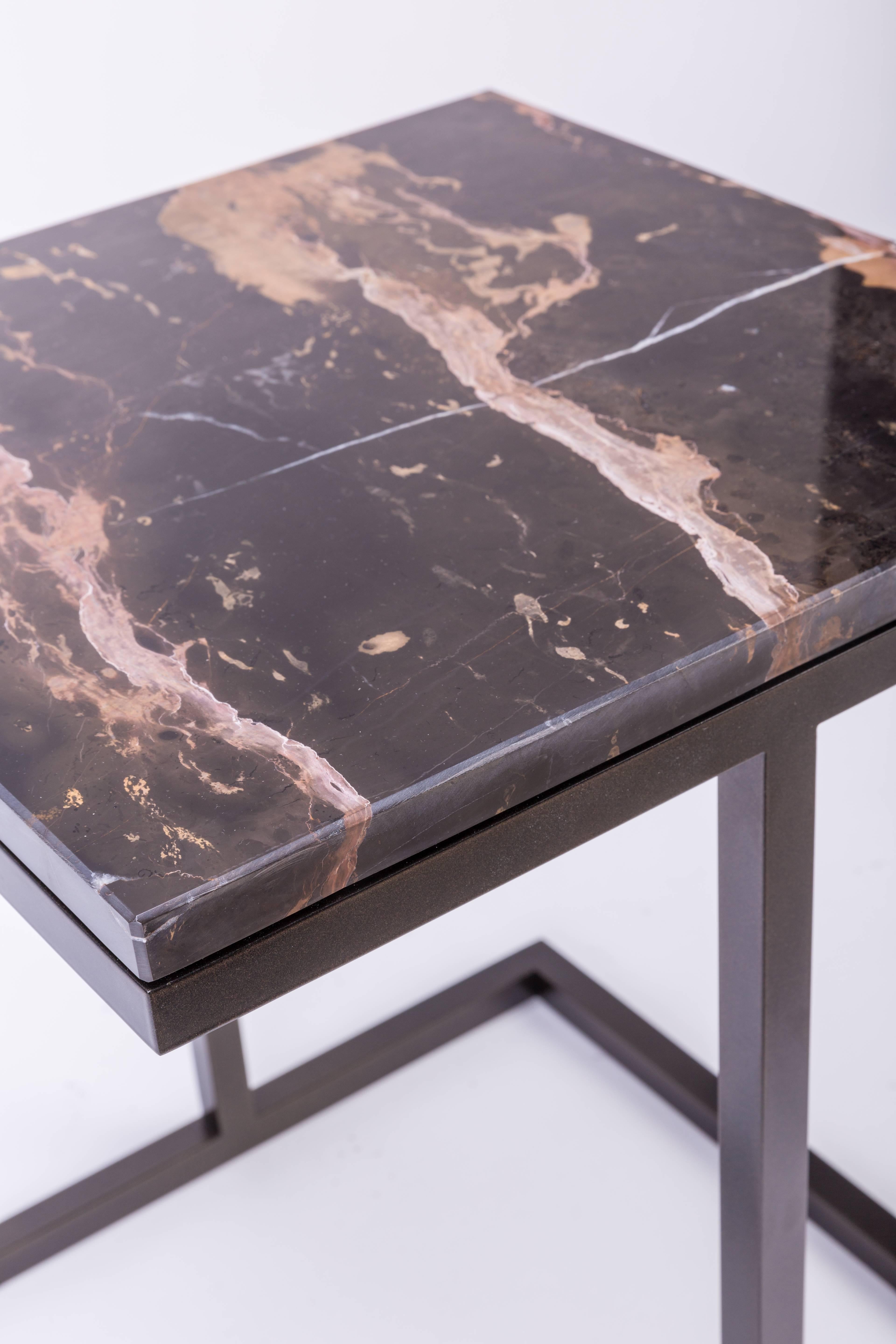 Combining the elegance and simplicity of a square marble top with a structural steel base, the Bacco coffee table attains sharp, contemporary aesthetics. The striking table comes with a choice of three luxurious surface options, including dark gold,