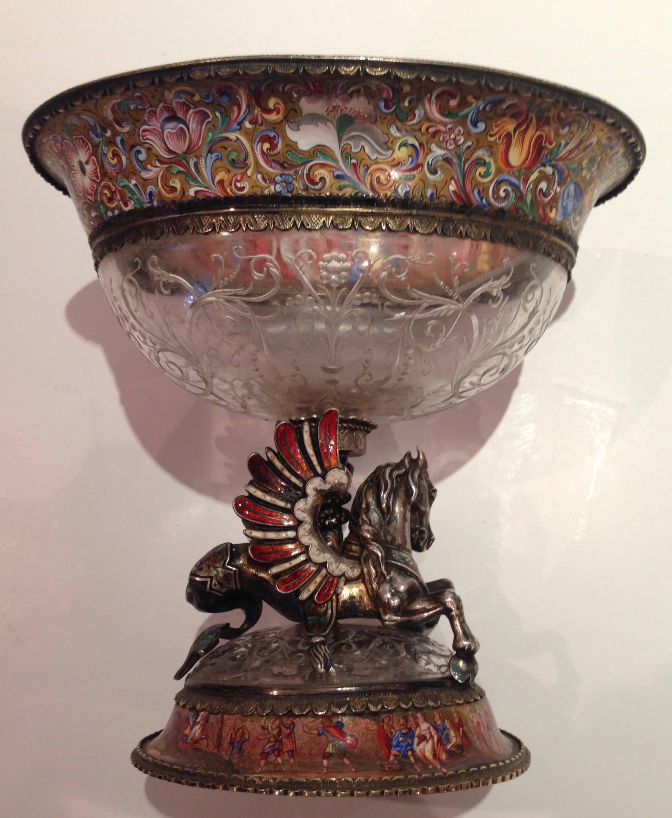 Beautiful enamel and finely engraved rock crystal coupe by Karl Bender 1874-1892. The wide border to the engraved rock crystal bowl is decorated with mythological figures supported by a silver Pegasus with outspread enamel wings.
