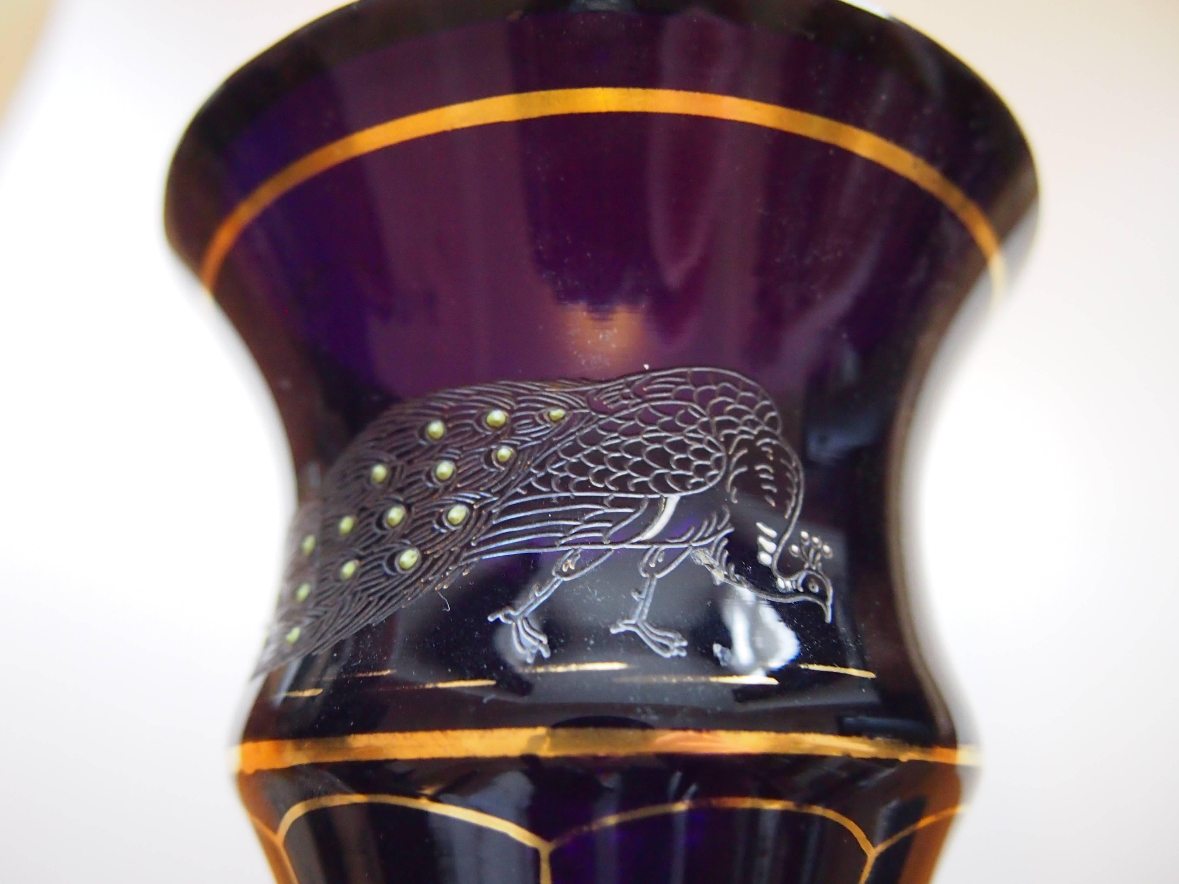 Stunning dark purple vase enameled, gilded and cut, depicting a peacock, definitely from the Haida region in what was then Bohemia and from the shape probably by Lorenz, circa 1910. 

Haida, now known as Novy Bor, was one of the greatest Bohemian