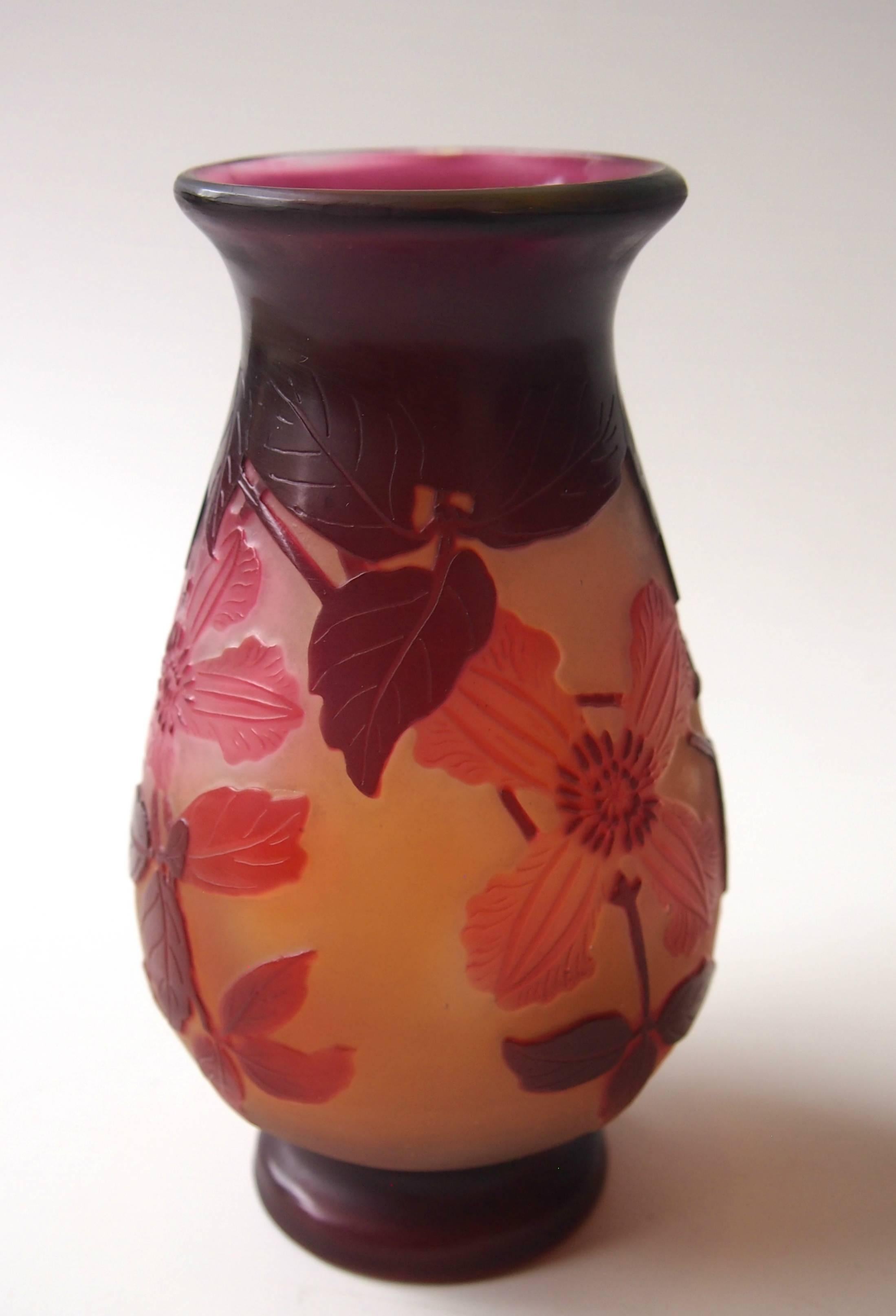 Fine Emile Galle Art Nouveau cameo vase decorated with trailing clematis flowers, in yellow, purple pink and red internally polished. Signed in Cameo

This vase feature a rarer Galle time consuming technique of selective internal polishing, at the